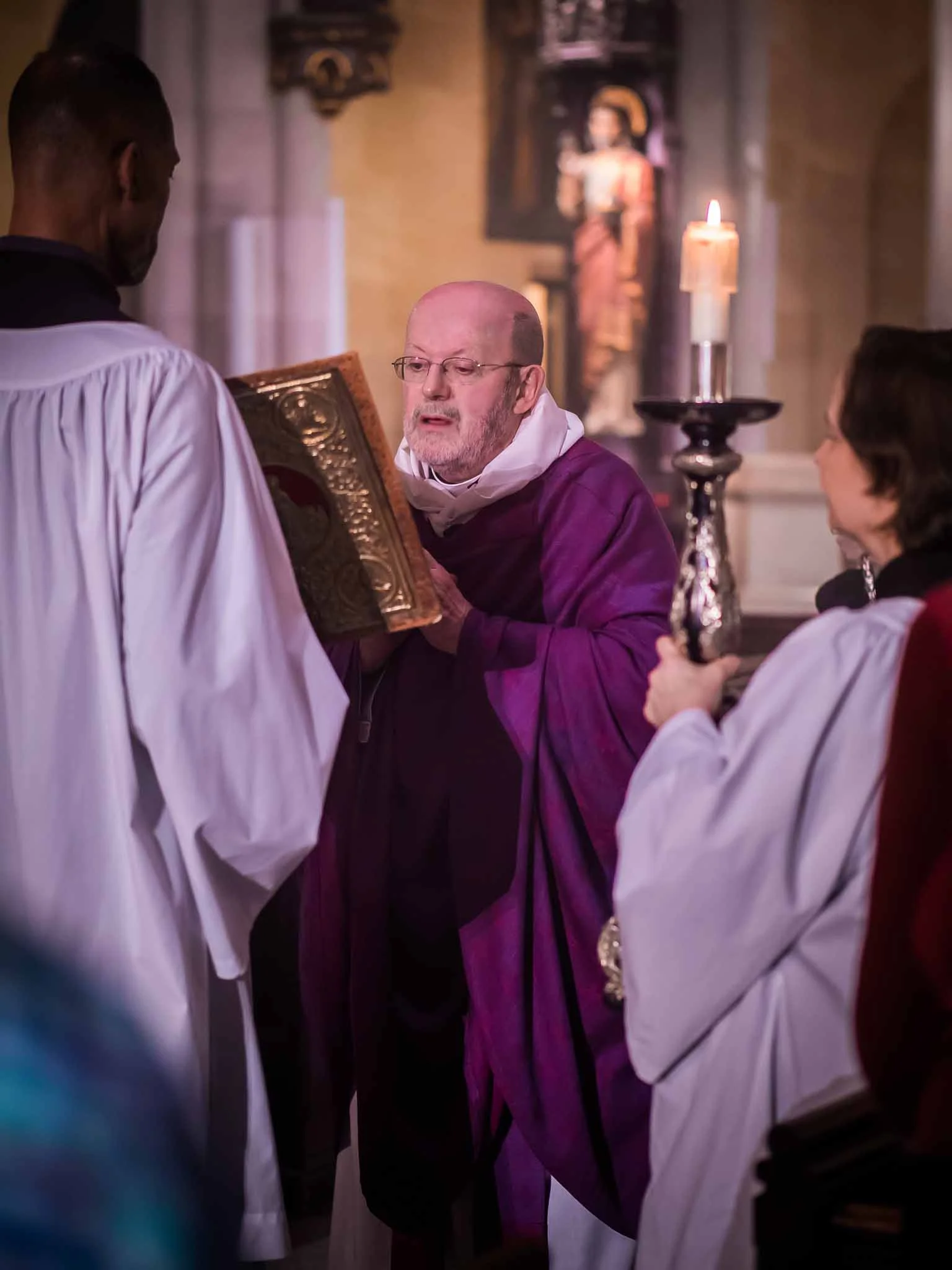 Charles Carson (L), Father Jay Smith, and Marie Postlewate at the proclamation of the gospel. Photo by Ricardo Gomez
