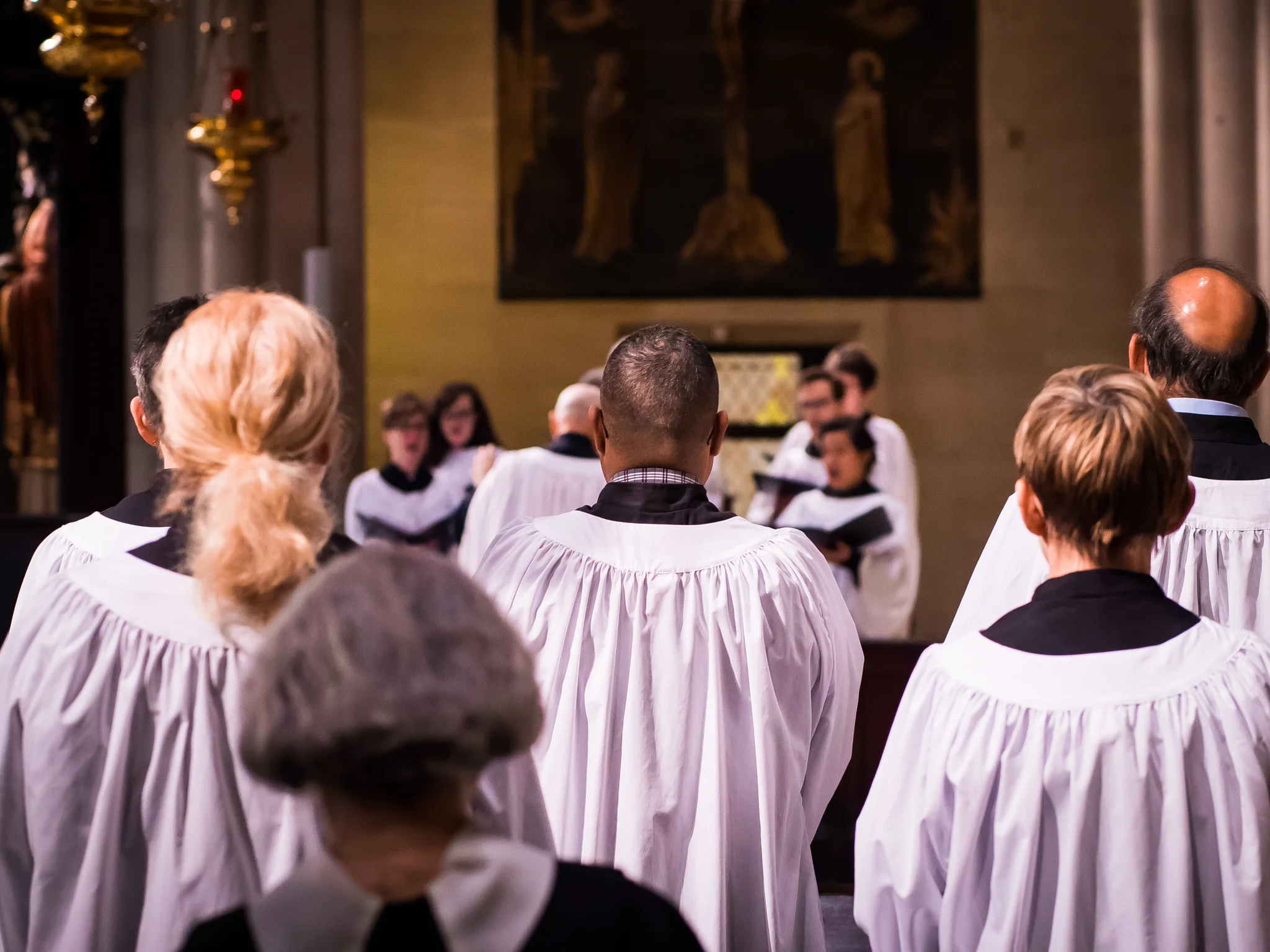The acolytes, and sisters, listen to the choir at the Solemn Mass. At center, from the back: Luis Reyes serves as acolyte for the first time. Photo by Ricardo Gomez