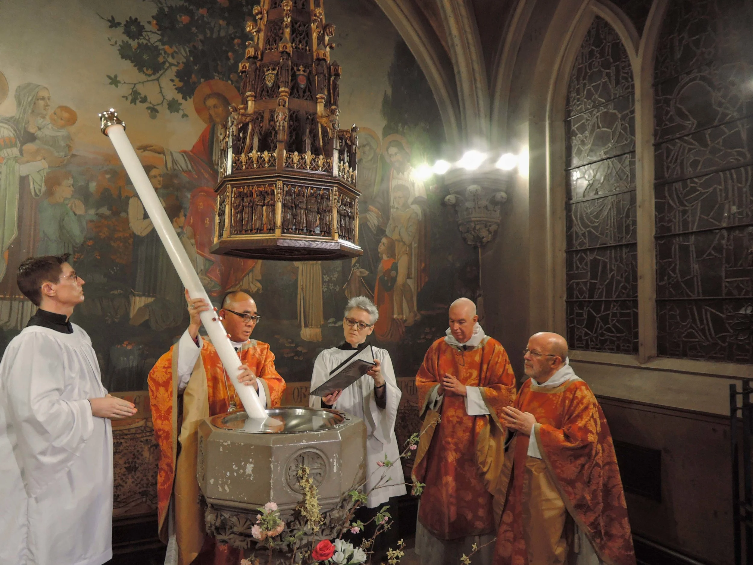 The Paschal Candle is plunged into the font during the Thanksgiving over the Water. Photo by Sister Monica Clare, C.S.J.B.