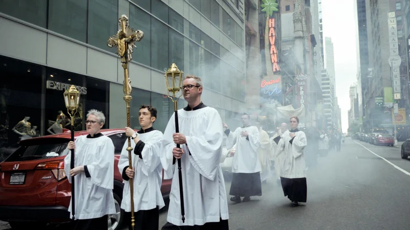 The procession moves to Times Square. The cross leads the procession. Photo by Ricardo Gomez