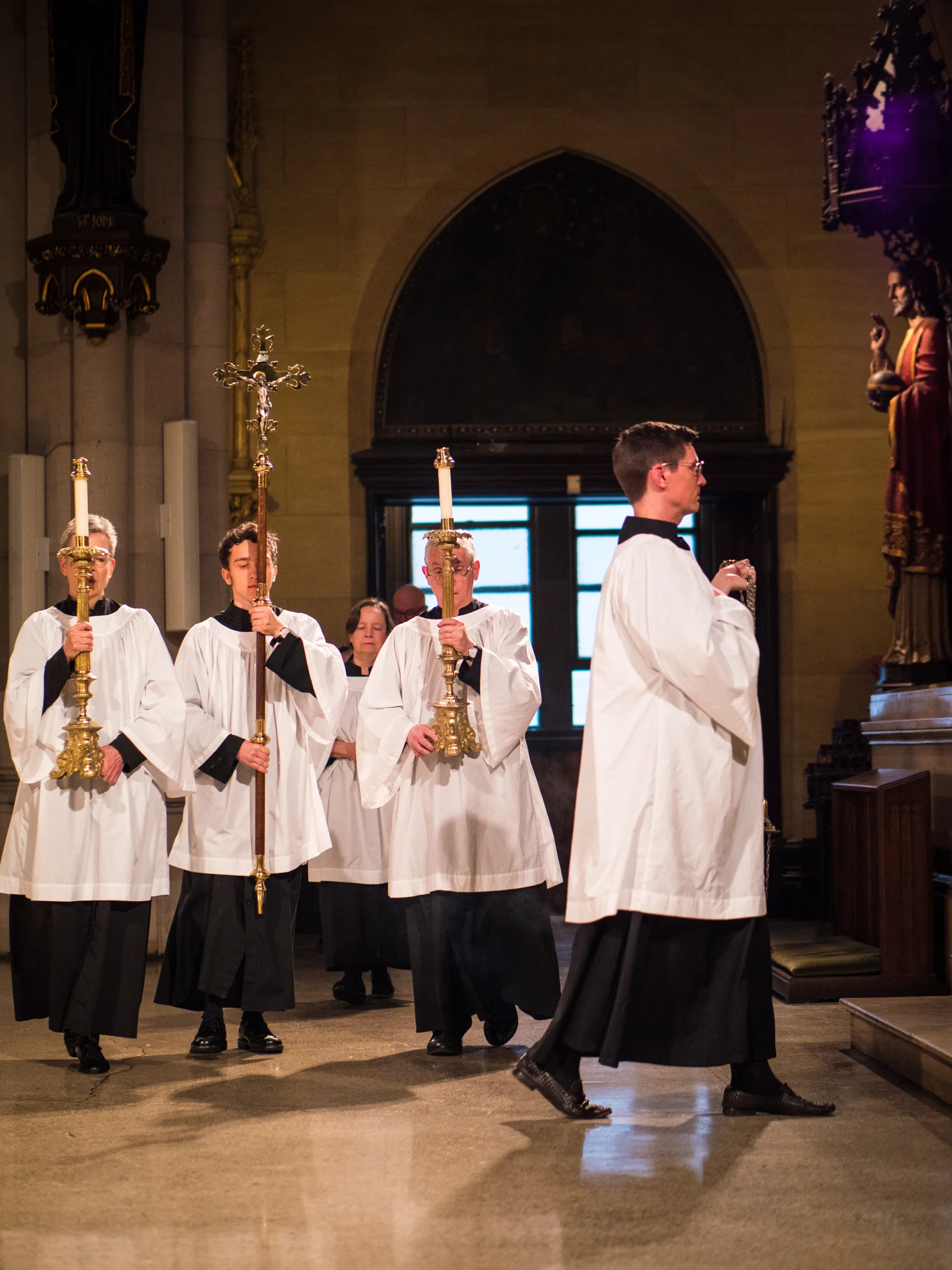 At the entrance. A tradition continues: Our acolytes and clergy wear black cassocks, black socks, and black shoes while serving at the altar. Photo by Ricardo Gomez