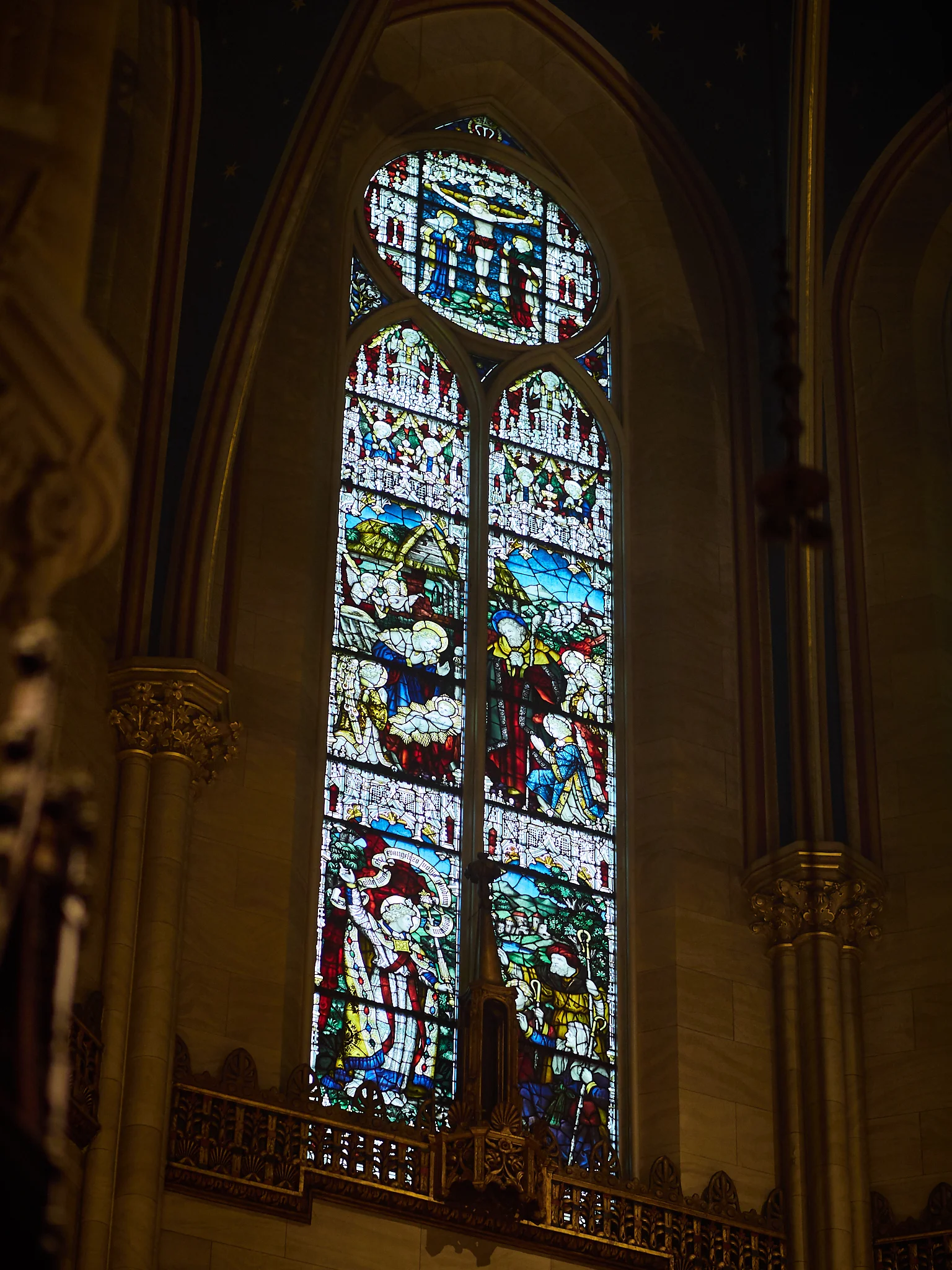 Central double-lancet window in apse: Roundel at top: The Crucifixion; Center: Adoration of the Shepherds; Bottom: Angel Appears to Shepherds Photo by Ricardo Gomez