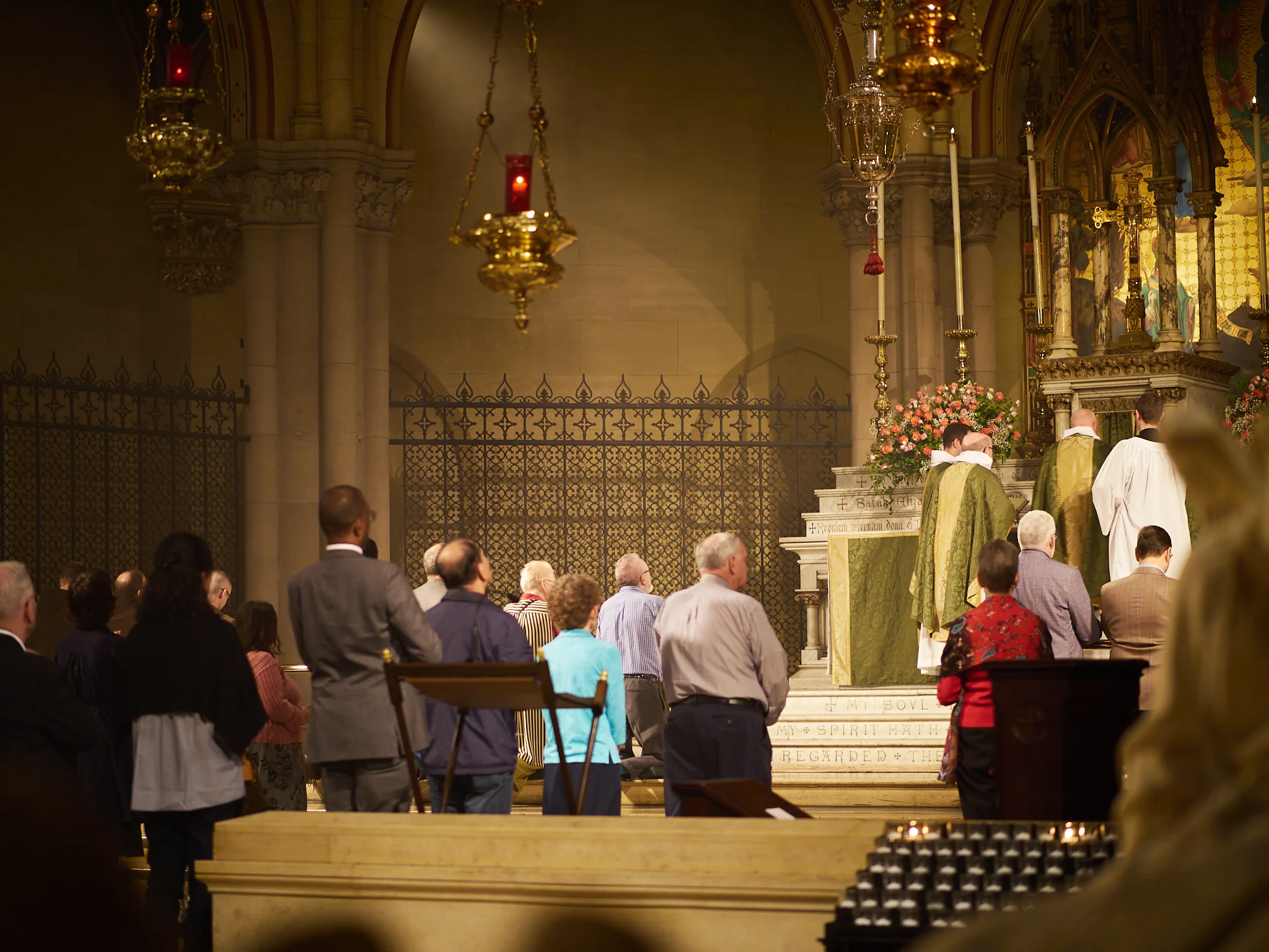 The moment before the ministers of the Sacrament deliver the Sacrament to the congregation. Other servers behind the altar rail will receive from the ministers who will carry the Sacrament persons in the congregation and to the organ gallery. Photo by Ricardo Gomez