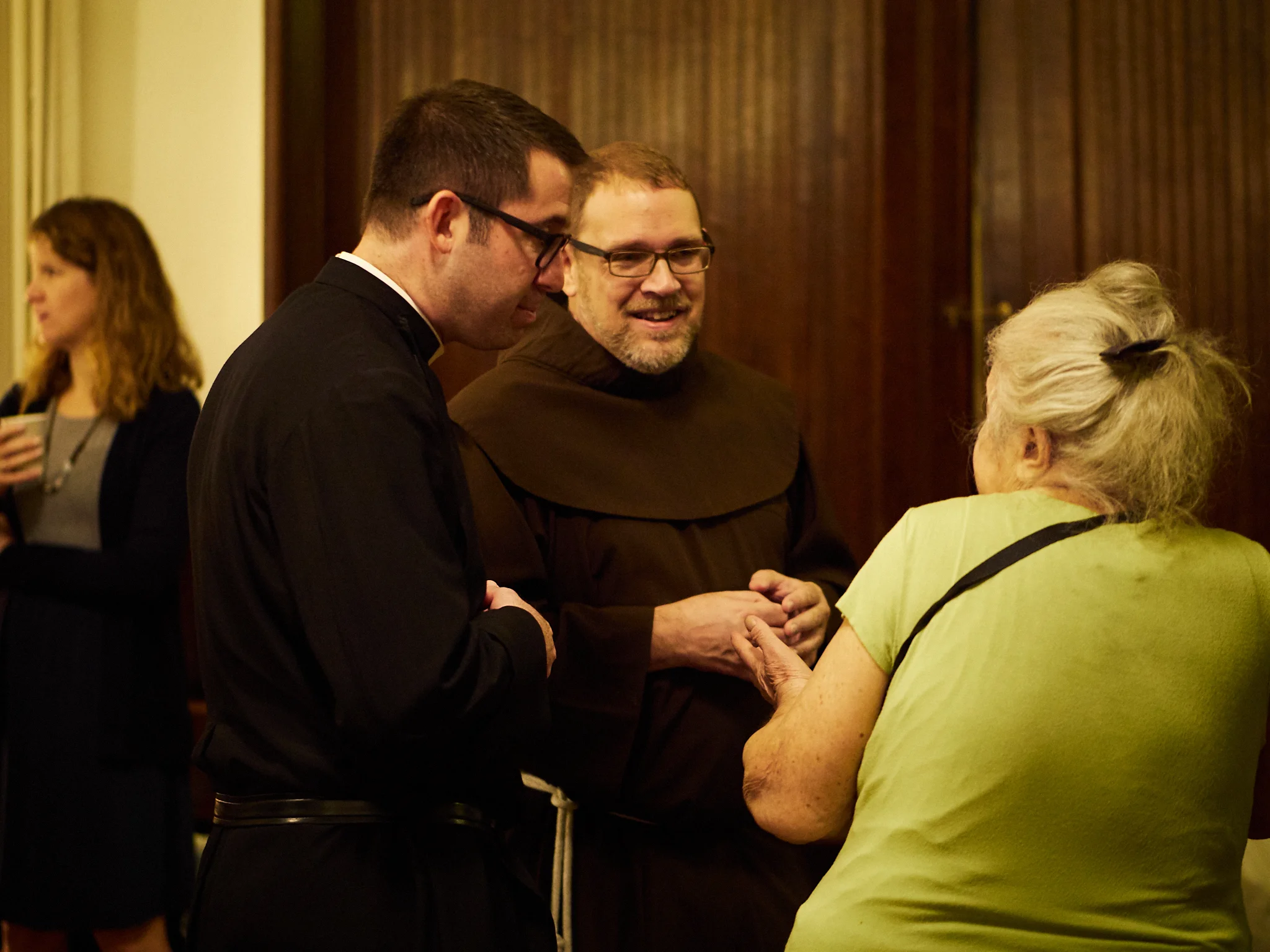 At coffee hour: Fr. Matt Jacobson (L) and Br. Damien Joseph, S.S.F, greet members of the congregation. Photo by Ricardo Gomez