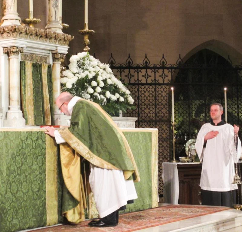 The celebrant, in this case Father Jay Smith, is the last of the clergy to reverence the altar at the beginning of the Solemn Mass. Photo from Sunday, February 3, 2019. Photo by MaryJane Boland