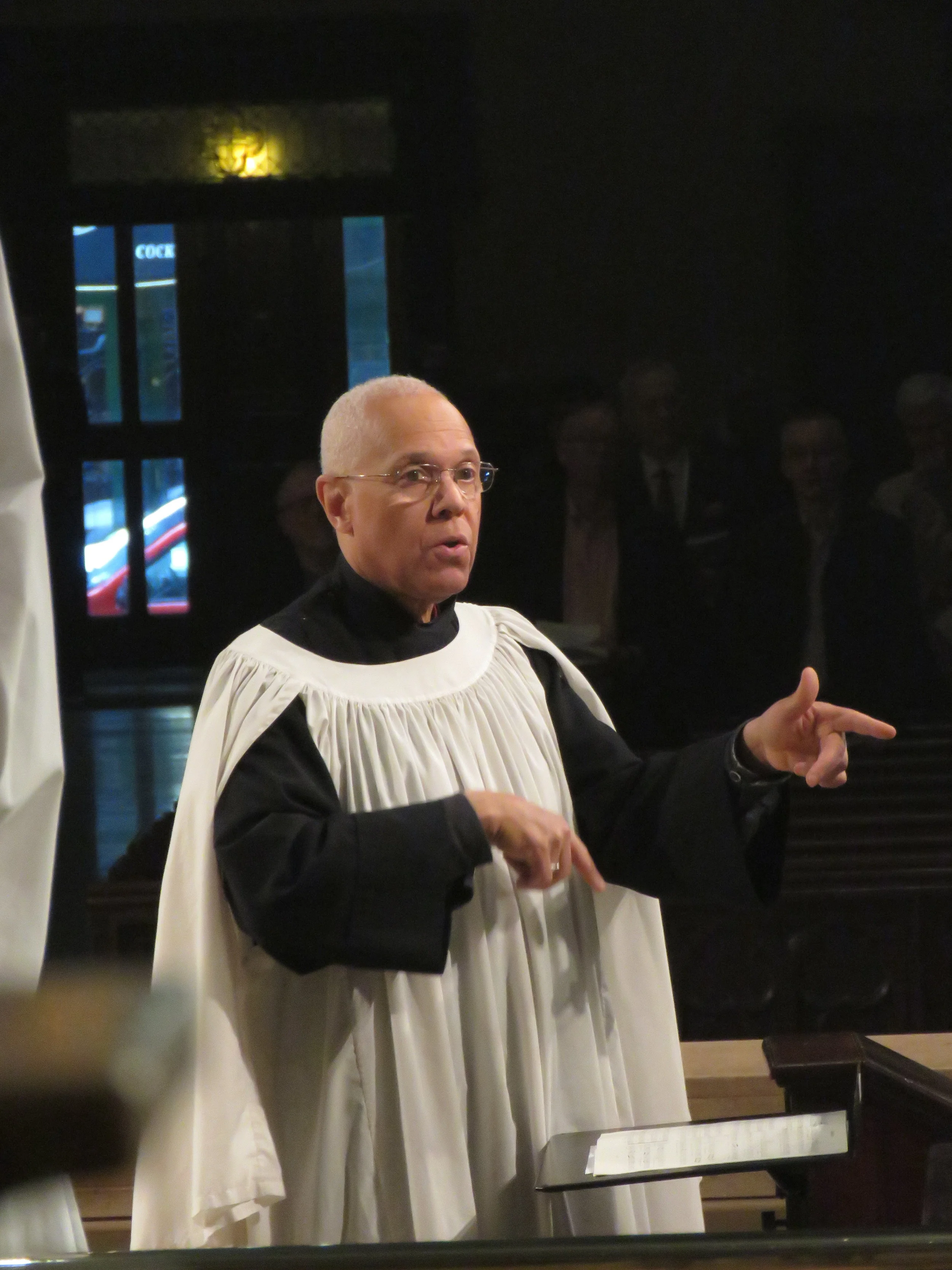 Dr. Hurd conducts the choir singing Sanctus et Benedictus from Missa Iste Confessor by Palestrina ( c . 1525-94). The perspective gives the illusion that Dr. Hurd is not almost a city block away from the doors behind him. Photo by Damien Joseph SSF