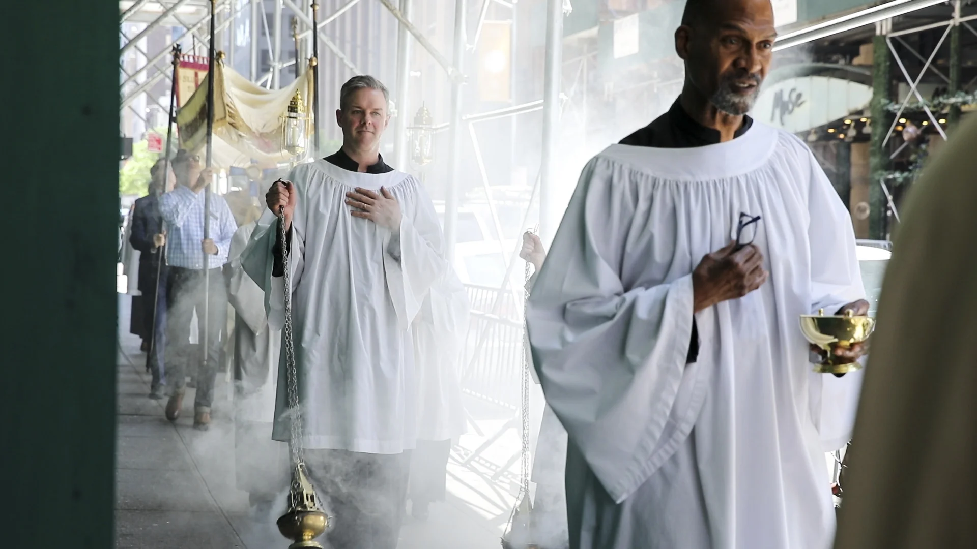 The procession is led by servers and the assisting priests. Acolytes with torches precede and follow the Sacrament. Photo: Pamela Pasco