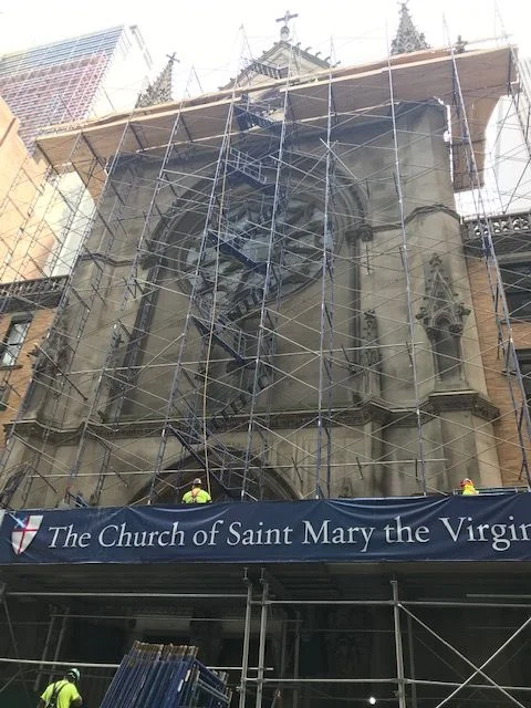 Scaffolding now reaches nearly to the top of the facade. A staircase can be seen in the center of the scaffolding. Photo: Jay Smith