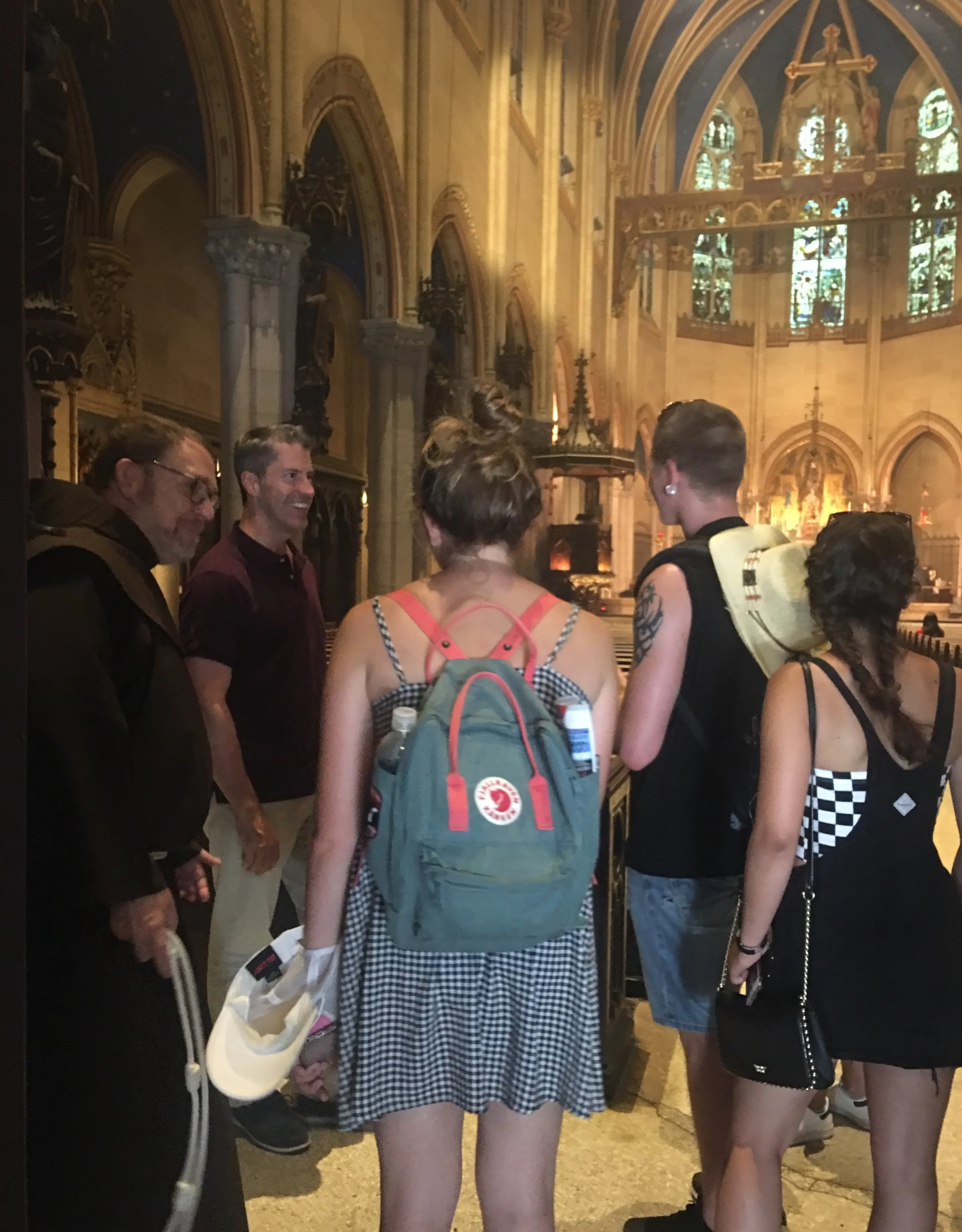 Br. Damien (L) and Mark Risinger greet a family of eight from Florence, Italy, after the Solemn Mass. Photo: Renee Pecquex