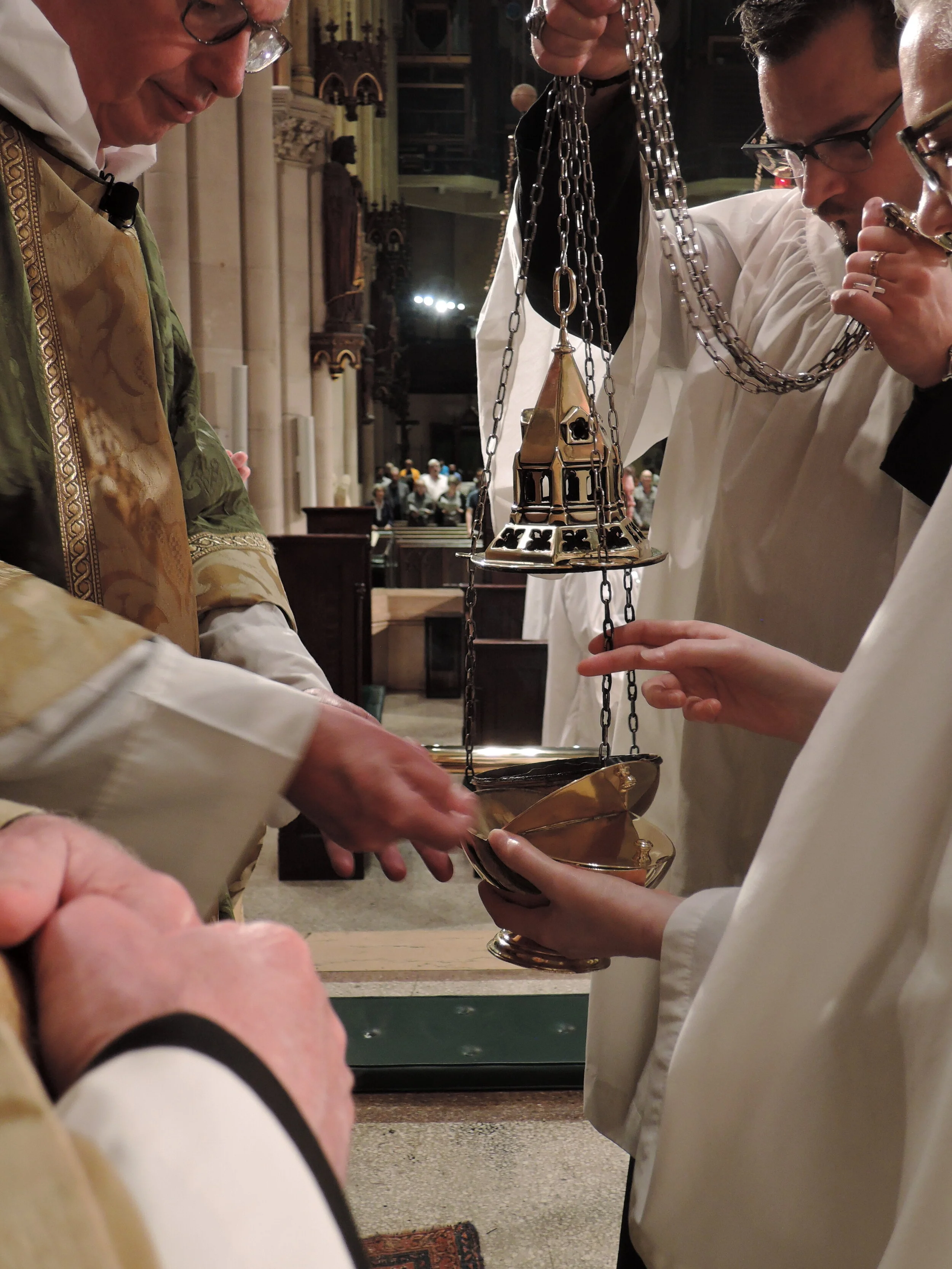 The thurible is charged before the proclamation of the gospel. Photo: Grace Mudd