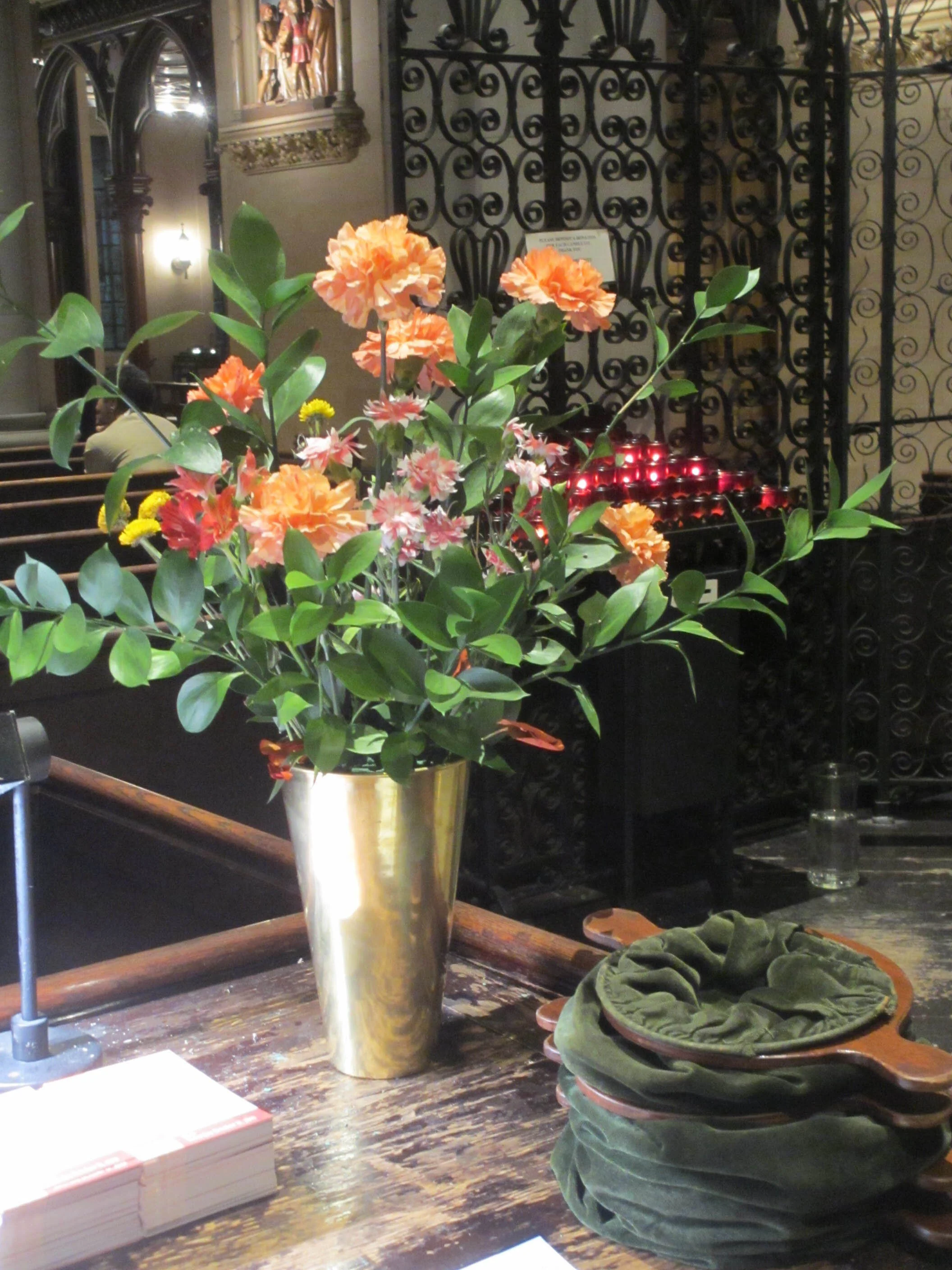 The flowers on the altar and here at the ushers' table were given for Sunday, September 15. With the right care during the days that followed, most of the flowers could be reused for the following Sunday. Photo: MaryJane Boland