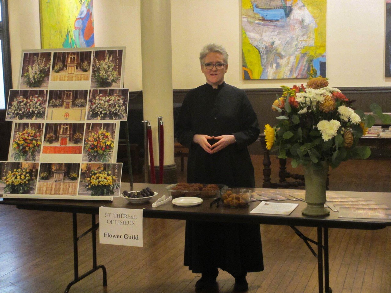 Marie Rosseels at the Flower Guild's Table. The guild members arrange the flowers whenever they are used in the church. All of the guild tables offered treats. Photo: MaryJane Boland
