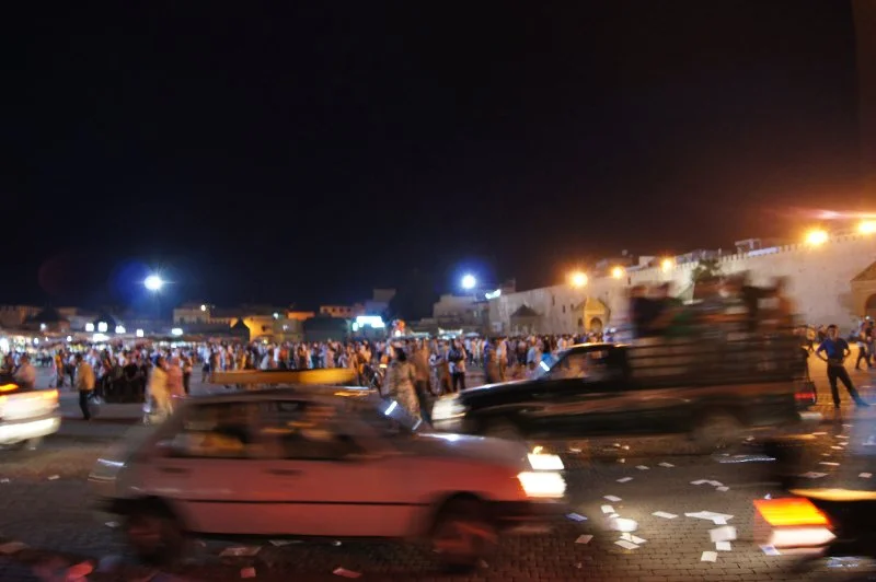 It's evening in Place el-hadim, the main square in Meknes' old city. Protesters disperse, leaving pro-constitution propaganda scattered across the ground. Summer, 2011.