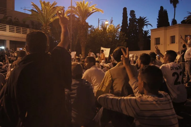 Protesters hold their hands up in rebellion. Fingers held in a 'V' signifying their dislike of the newly proposed constitution. The 'V' symbol translates to "la" the Arabic word for "no". Summer, 2011.