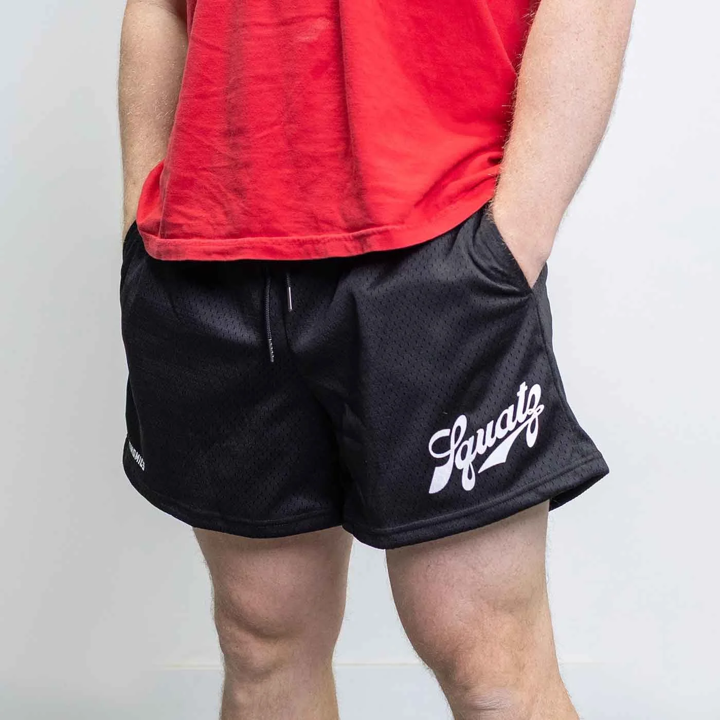 squats shorts model with hands in pockets
