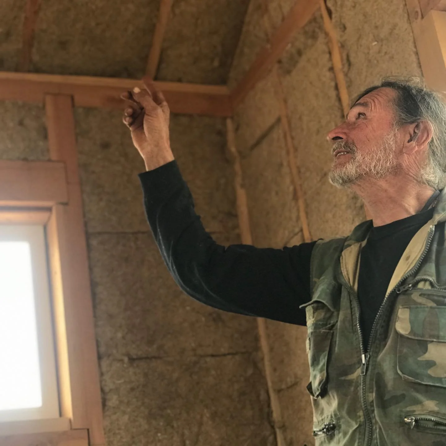Arnie Valdez, architect/farmer/builder of Rezolana farm points to eco-insulation  material of the future&mdash;#hempwool, made of industrial hemp fiber and Hurd. Half of Arnie&rsquo;s hemp sleeper cabin model utilizes Hempitecture&rsquo;s hempwool, a