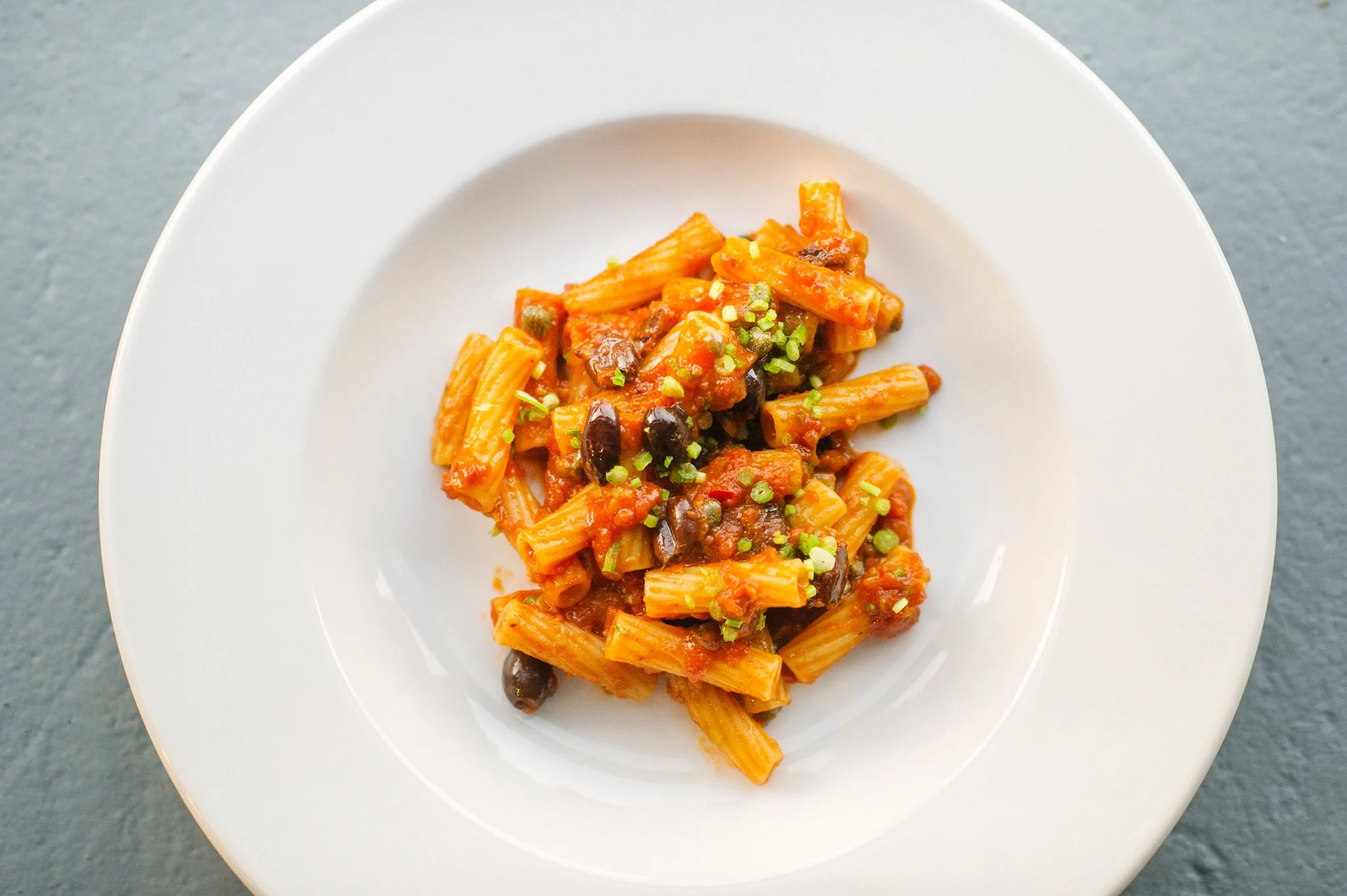 "Salty" by Chef Mark Ladner- Pasta Puttanesca with Anchovy, Capers, Olives, and Spicy Tomato.