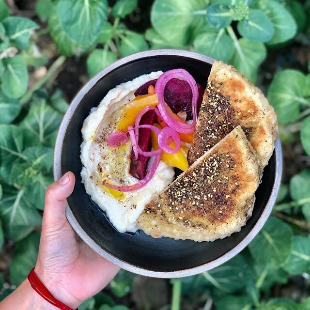 Come for a light snack. Lima bean spread, pickled winter vegetables, and fresh pita. Handmade ceramic plate by @jordancolon