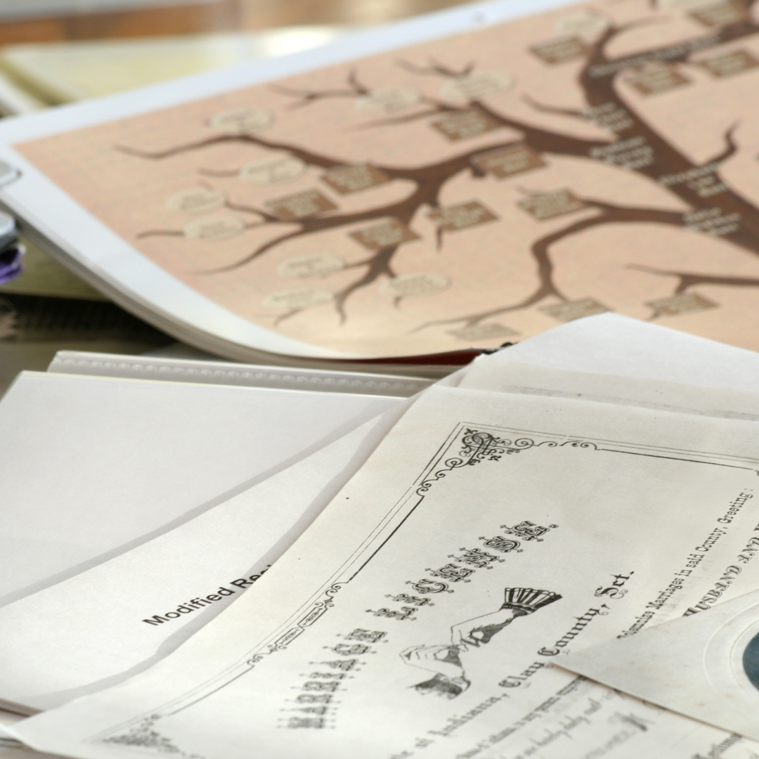 Image of papers and a family tree in blog posting on reasons forensic genealogy is different from traditional genealogy