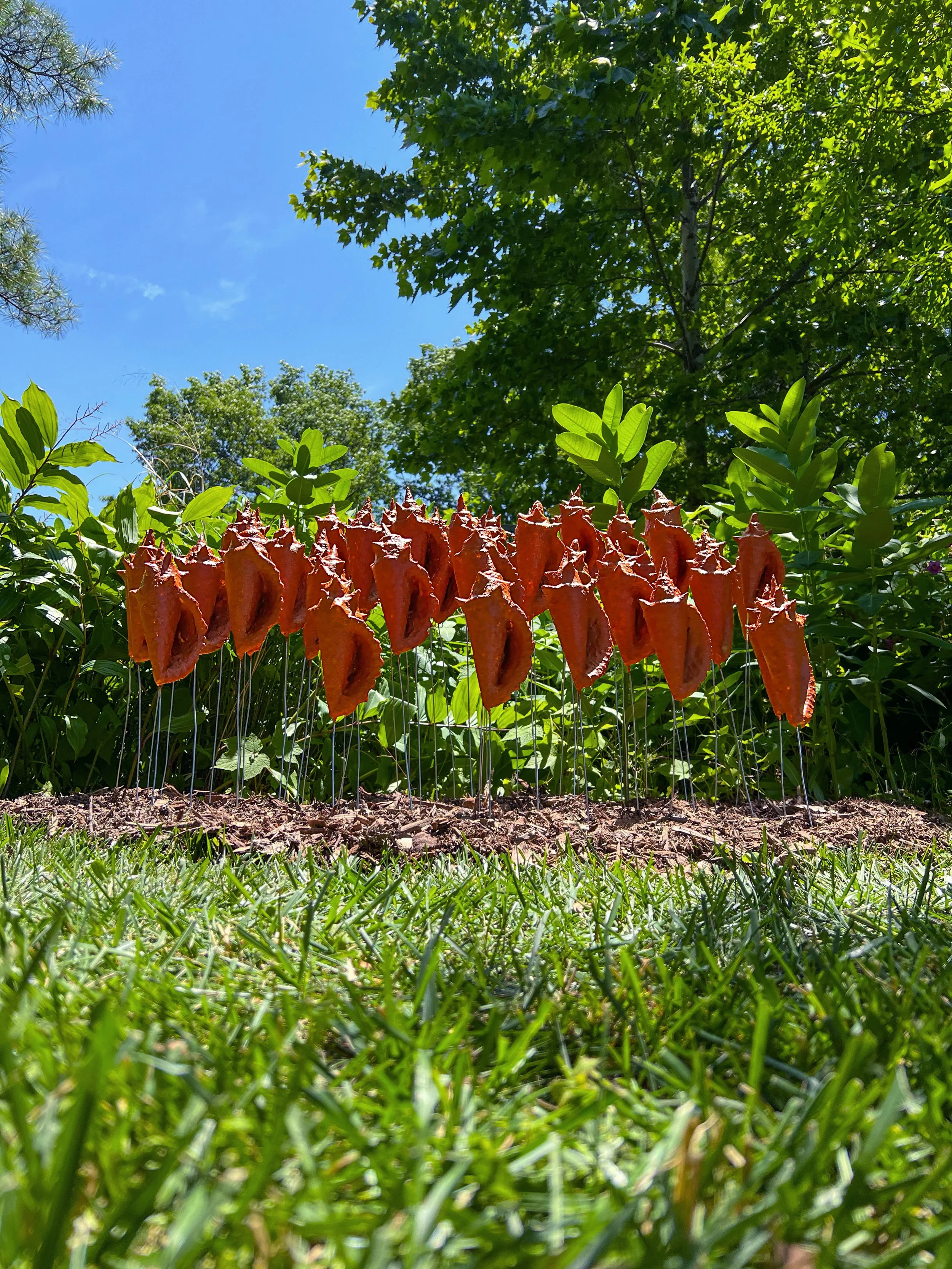  Resonantias. 2022.   Annatto powder, styrofoam, acrylic medium and galvanized wire. - Photo courtesy of the artist. - Outdoor installation at the  Queens Botanical Garden  for the exhibition “ Amplify ” as part of the   2022 Ankhlave Garden Project