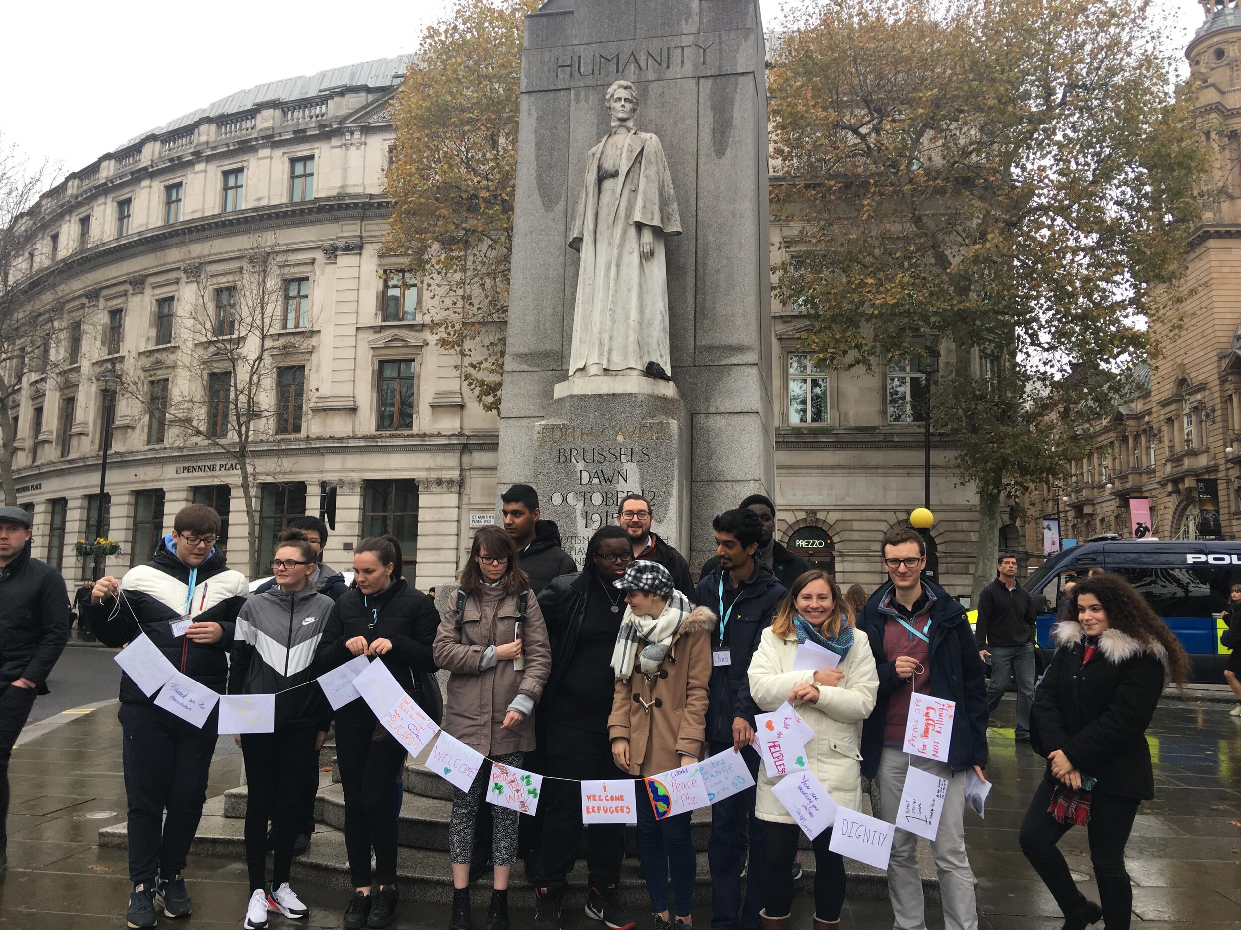 Group with banner in front of peace statue.jpg