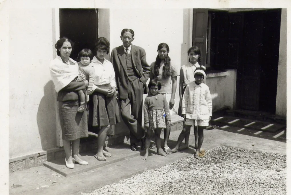 With her parents and sisters. She is sitting in my grandma’s arms.