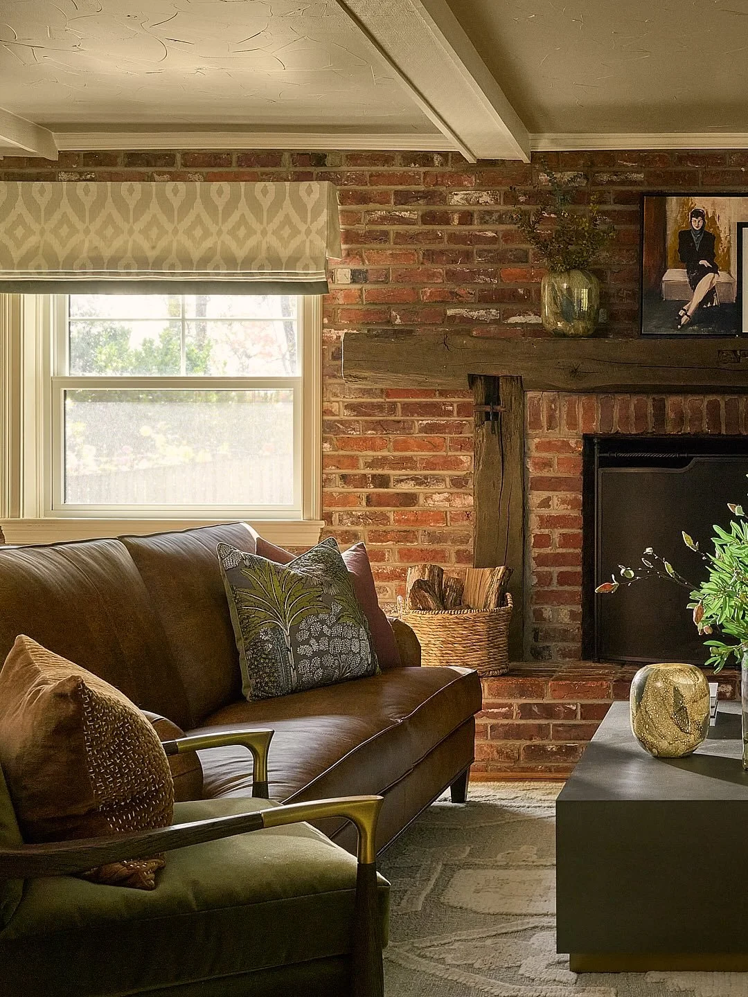 This living room was all about warmth and character - a place that feels storied yet comfortable. The brick fireplace and old beams set the tone, so we leaned into that cozy, collected feel with rich leathers, layered textiles, and timeless details.
