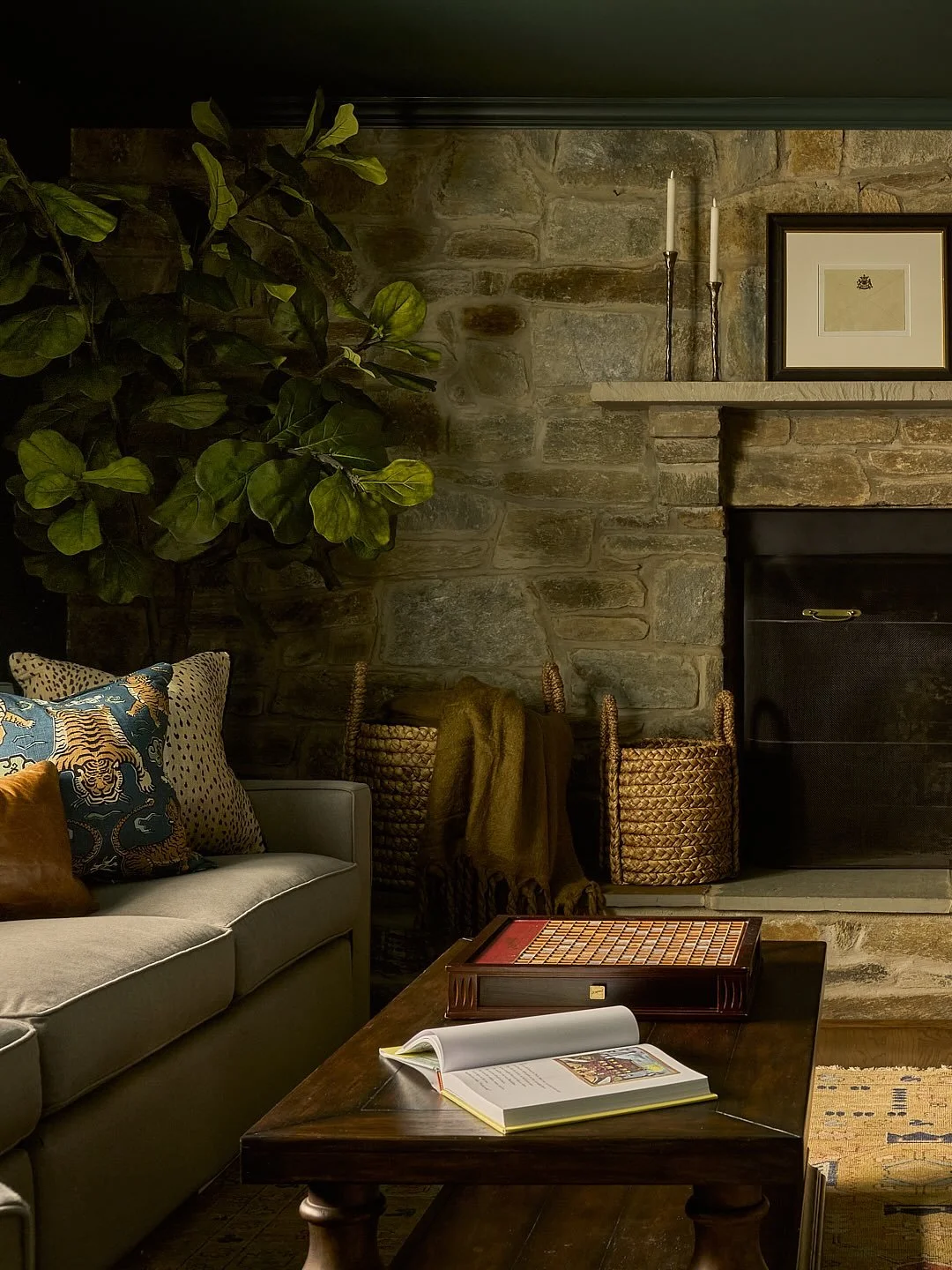 This room already had beautiful bones and cozy furniture - it just needed a touch of personality. We drenched the walls, trim, ceiling, and bookcases in Farrow &amp; Ball Grove Green, layered in fun custom accent pillows with luxurious velvet drapery