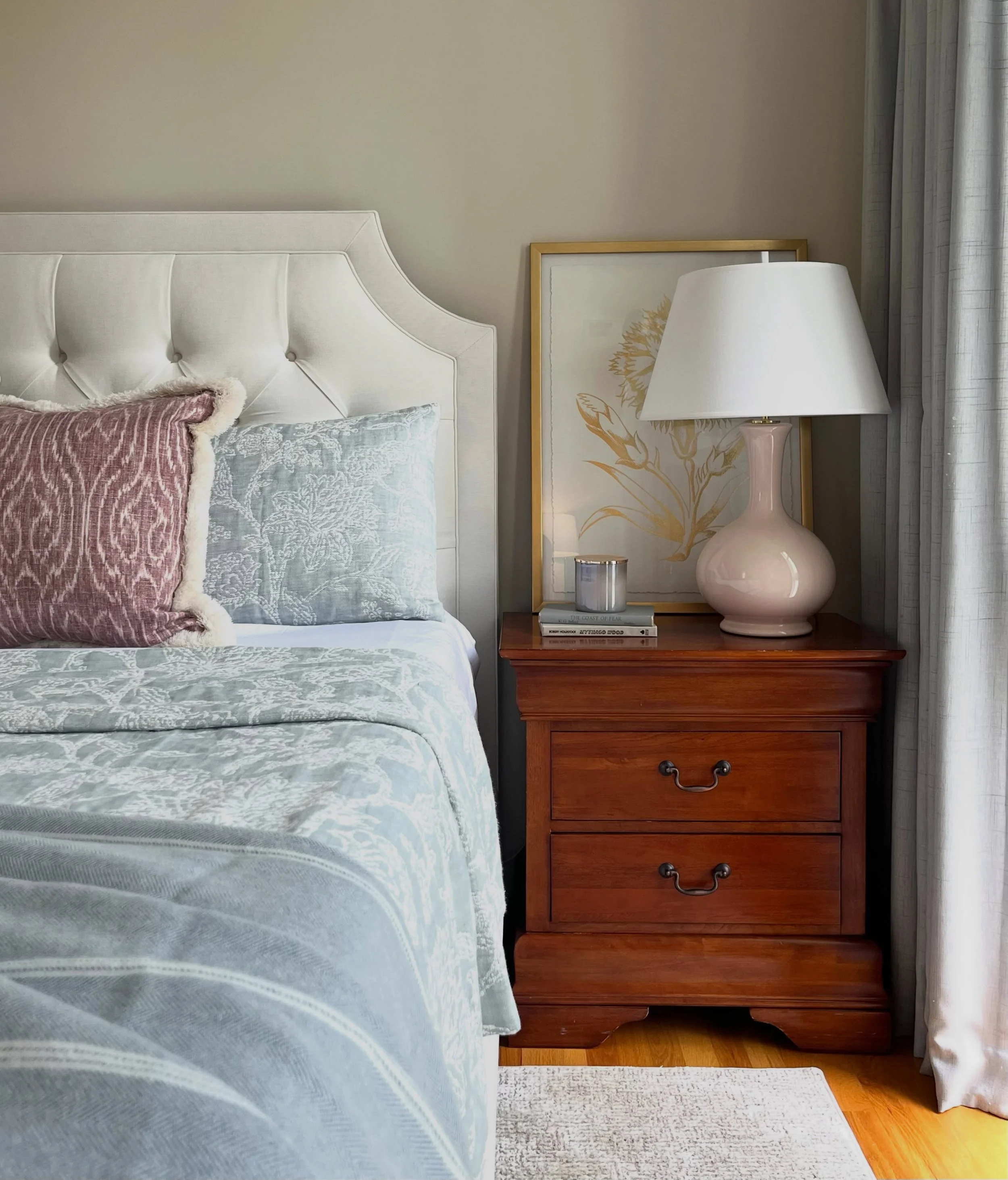 A closer look at the layers that brought this bedroom together - soft blue bedding, blush accents, warm wood and the existing drapery finally getting its moment with the perfect paint color.