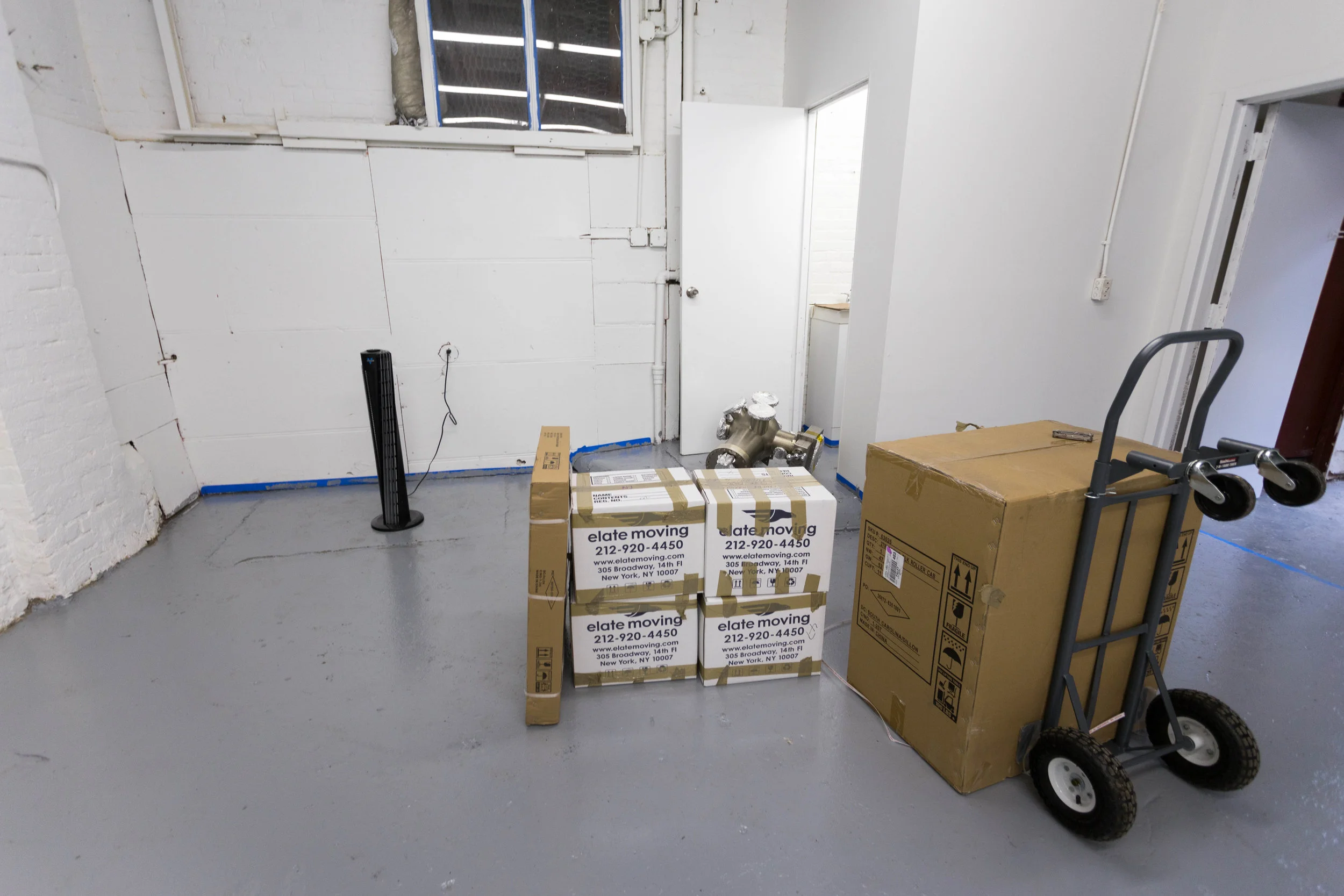 Some boxes and high vacuum equipment are being rolled in.