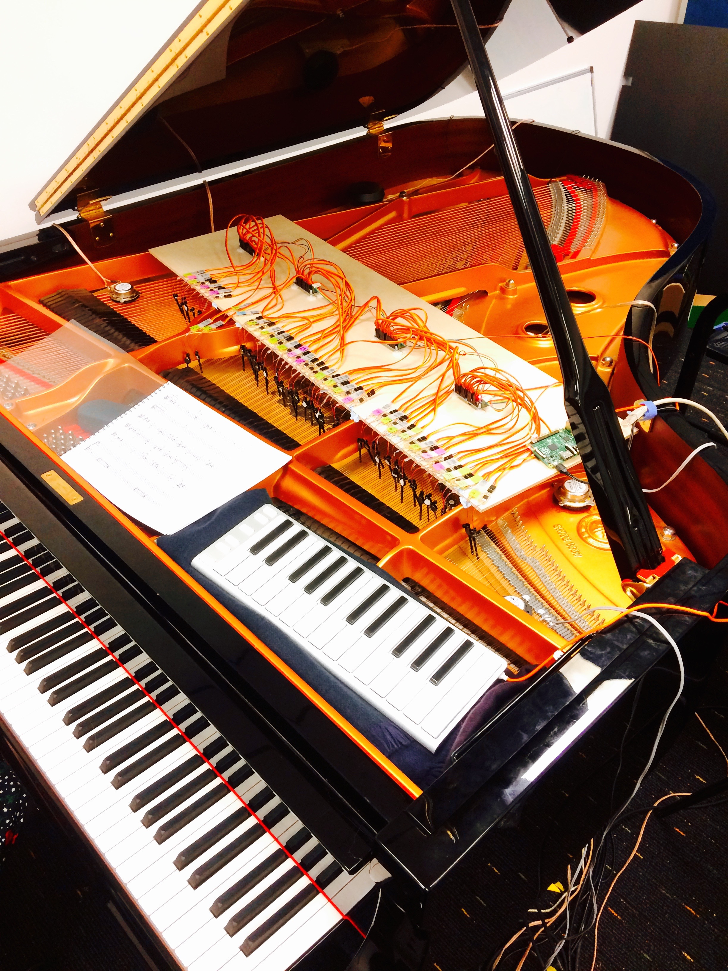 Robotic fingers, transducers, piano resonance feedback system installed in the piano at Goldsmith's Electronic Music Studio