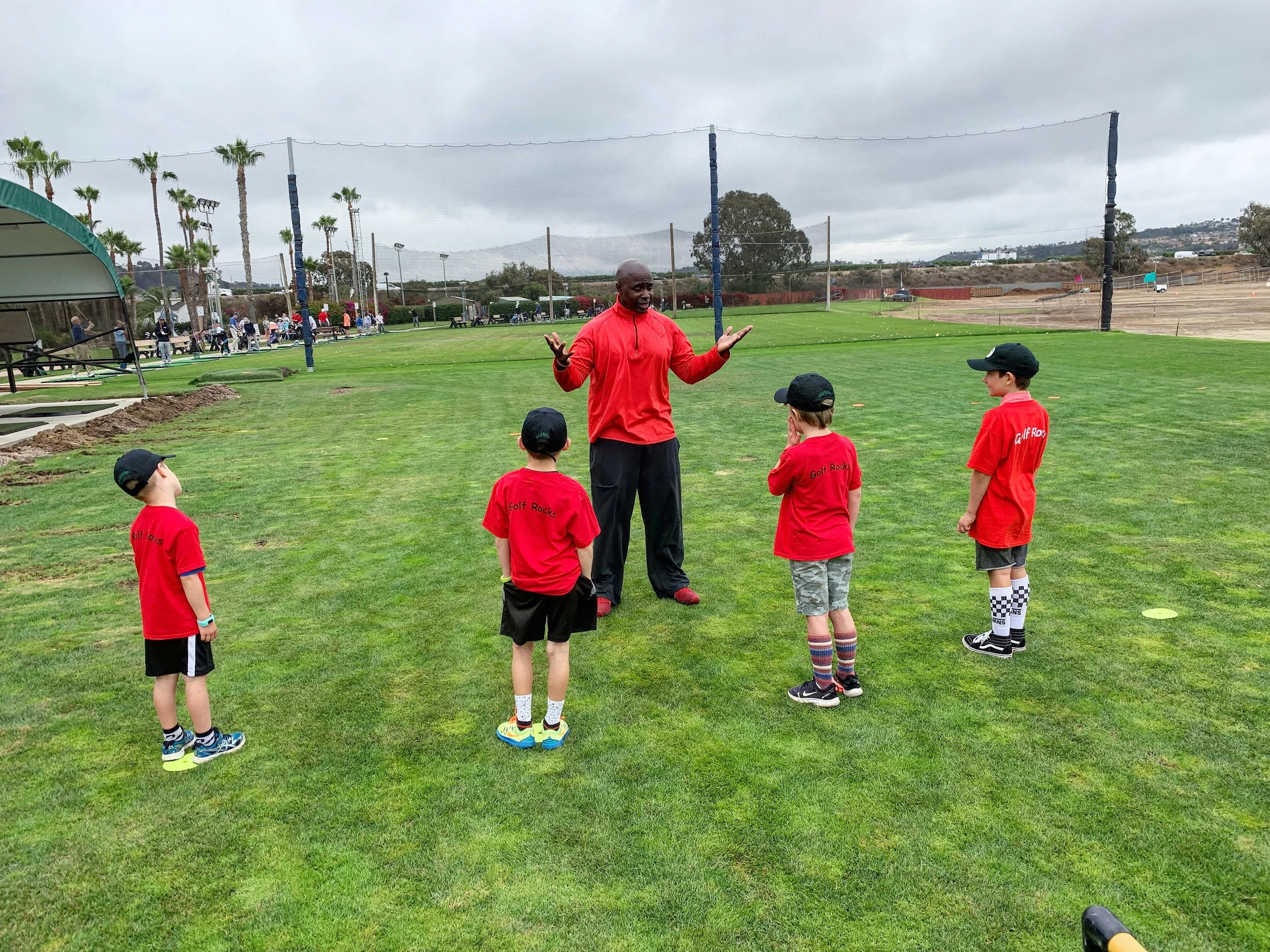 Coach Milo with Kids.JPG