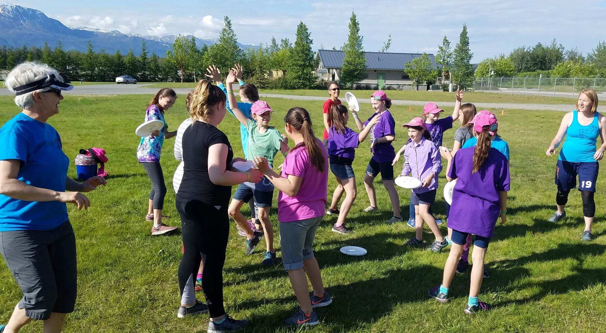 Girls scouts playing a spirit game called mingle to warm up and get to know each other at the start of the clinic.