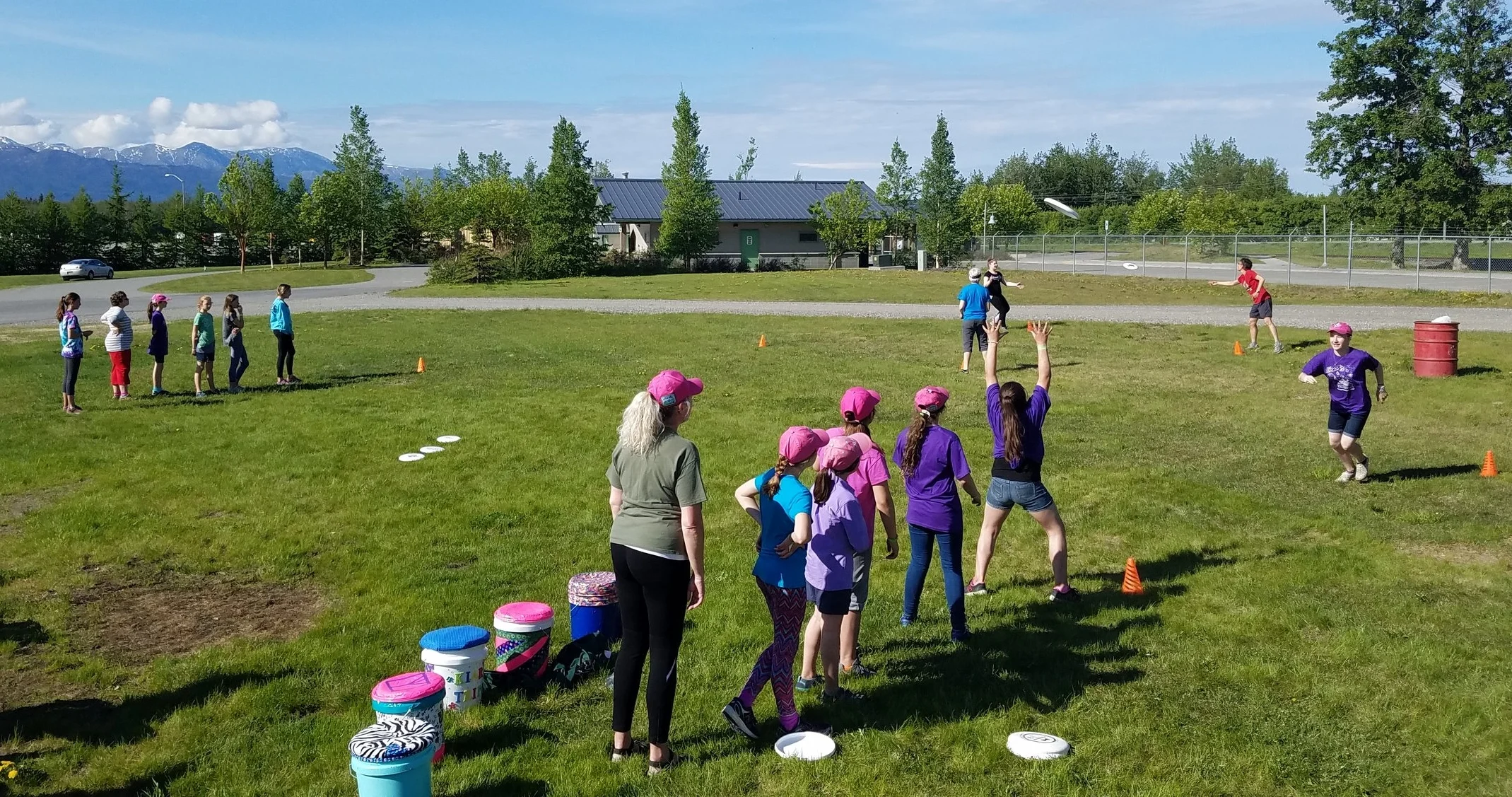 Leaders and girl scouts participated in a throwing relay to practice running & catching, stopping with the disc and throwing to space before playing a full game.