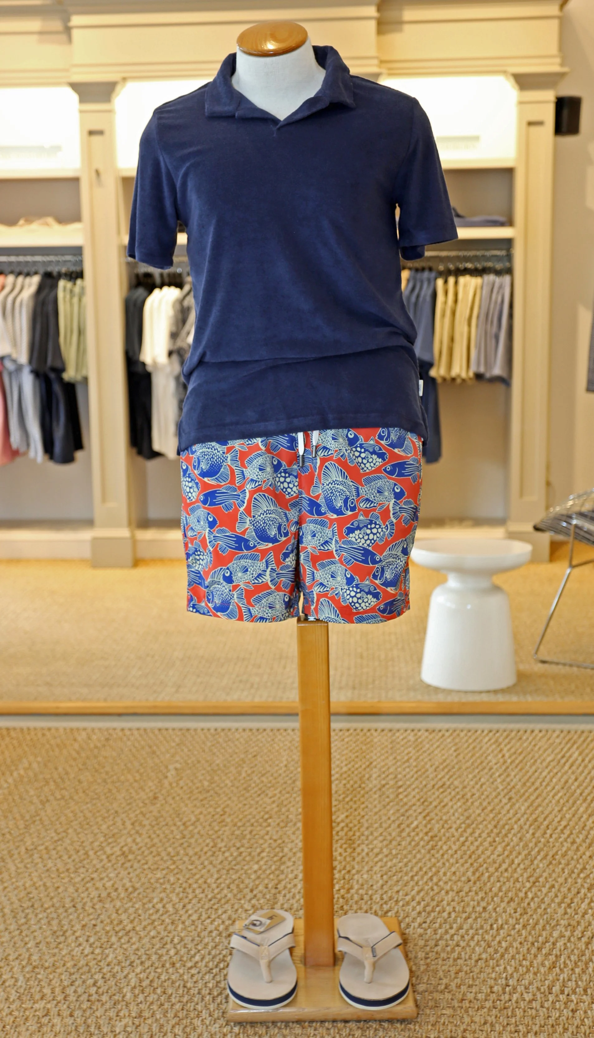   Onia Terry Johnny Collar Polo in Navy $120    Onia Charles 5” Swimsuit in Swimming Fish Pattern $195    Hari Mari Pier Flip Flop in Sand Nubuck $90  