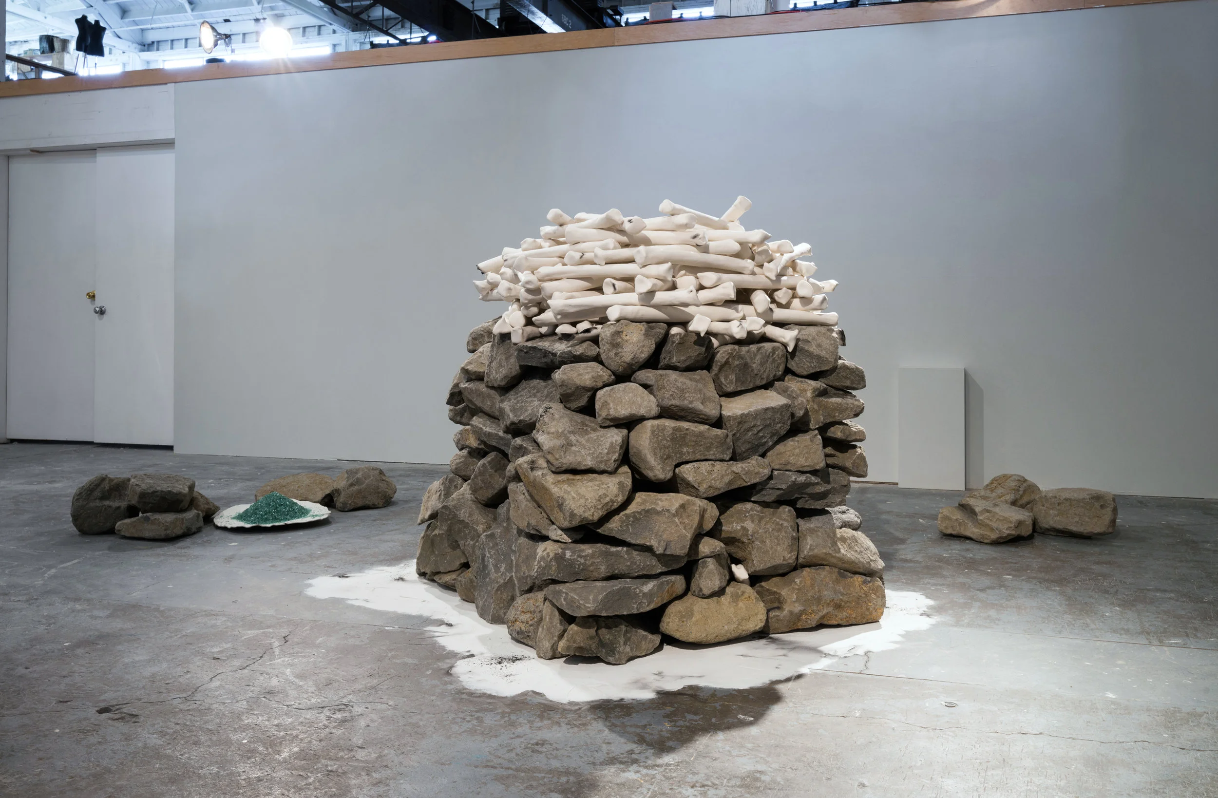   What We Know in Our Bones , 2017, installation view, basalt, porcelain, auto glass; photo by Mario Galluci. 