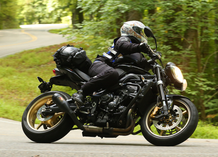 If I had gone the lowering route, there's absolutely no way I could lean over on my bike in a corner like this. As you can see, I'm definitely NOT dragging my knee, as I'm not leaning that far over. Bottoming out is a very real risk aside from the performance issues, that come along with lowering your sporty bike. Photo: Killboy.com 