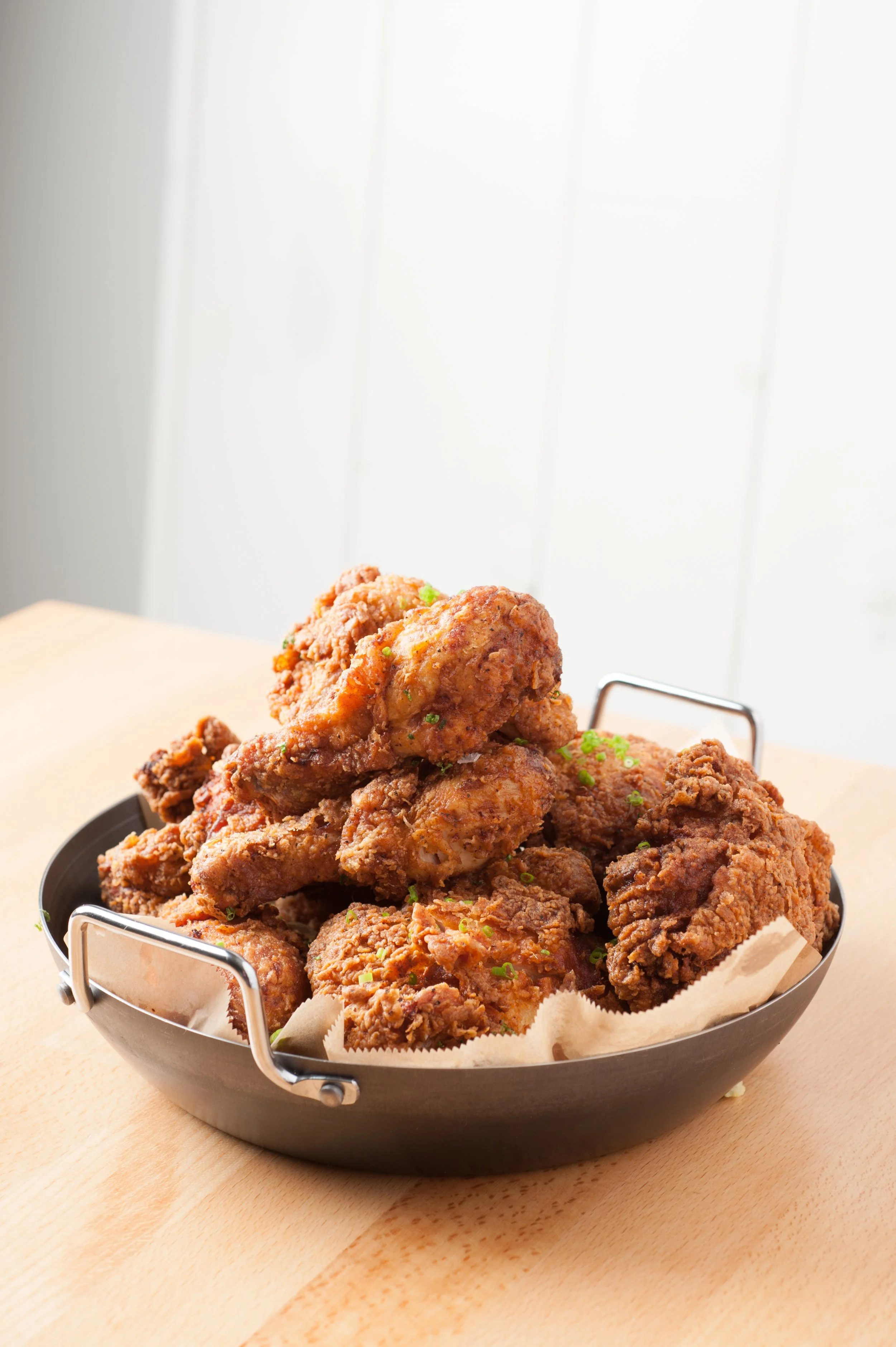 Close-up of golden fried chicken drumsticks and wings