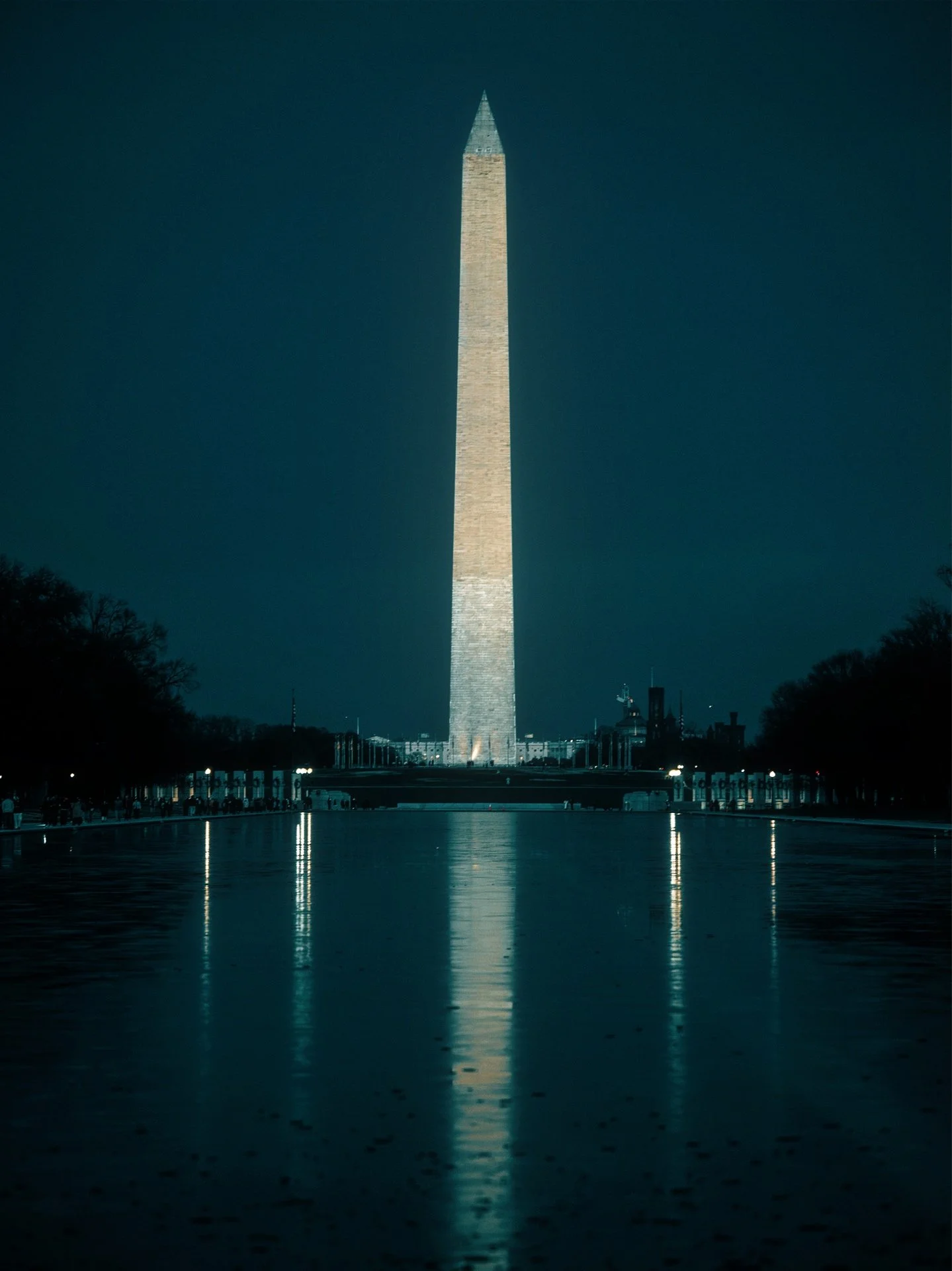 Nighttime view of the Washington Monument in Washington, D.C., with reflections on the Reflecting Pool.