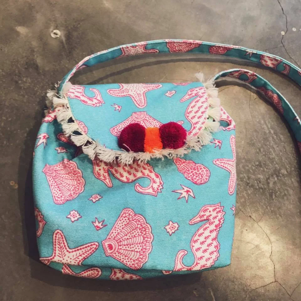 2. Vibrant blue block print pom-pom bag from Almirah Clothing