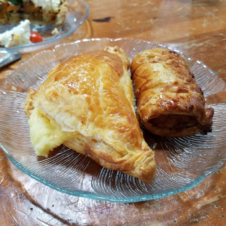 A Cheese Pasty (left) and a Sausage Roll—the magic is inside.
