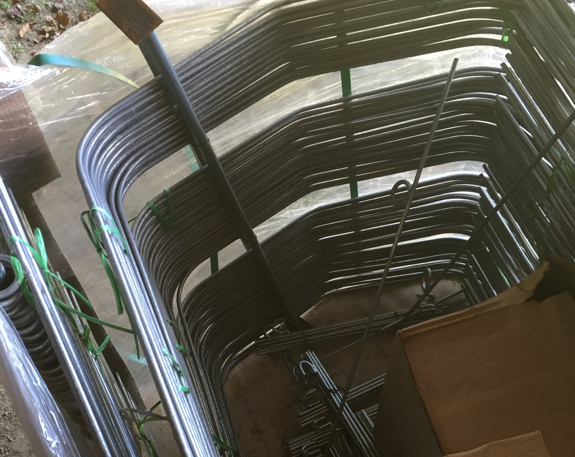 Low-tunnel hoops, with anchor stakes below.