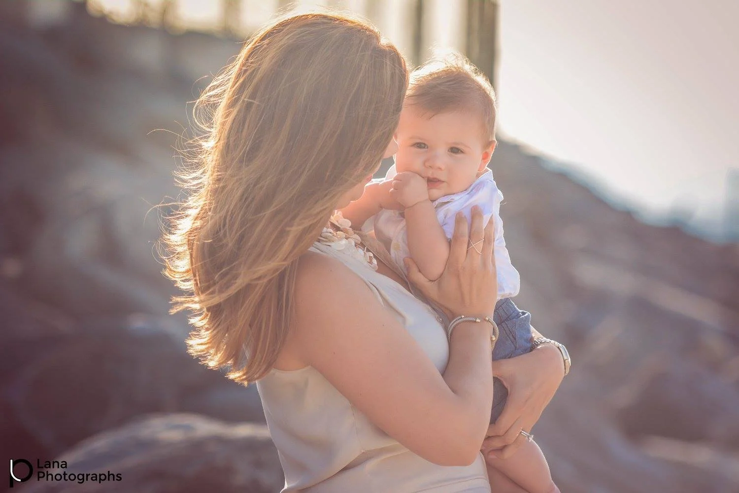 Dubai Family Photography Session portrait of a mother holding her little son by the ocean