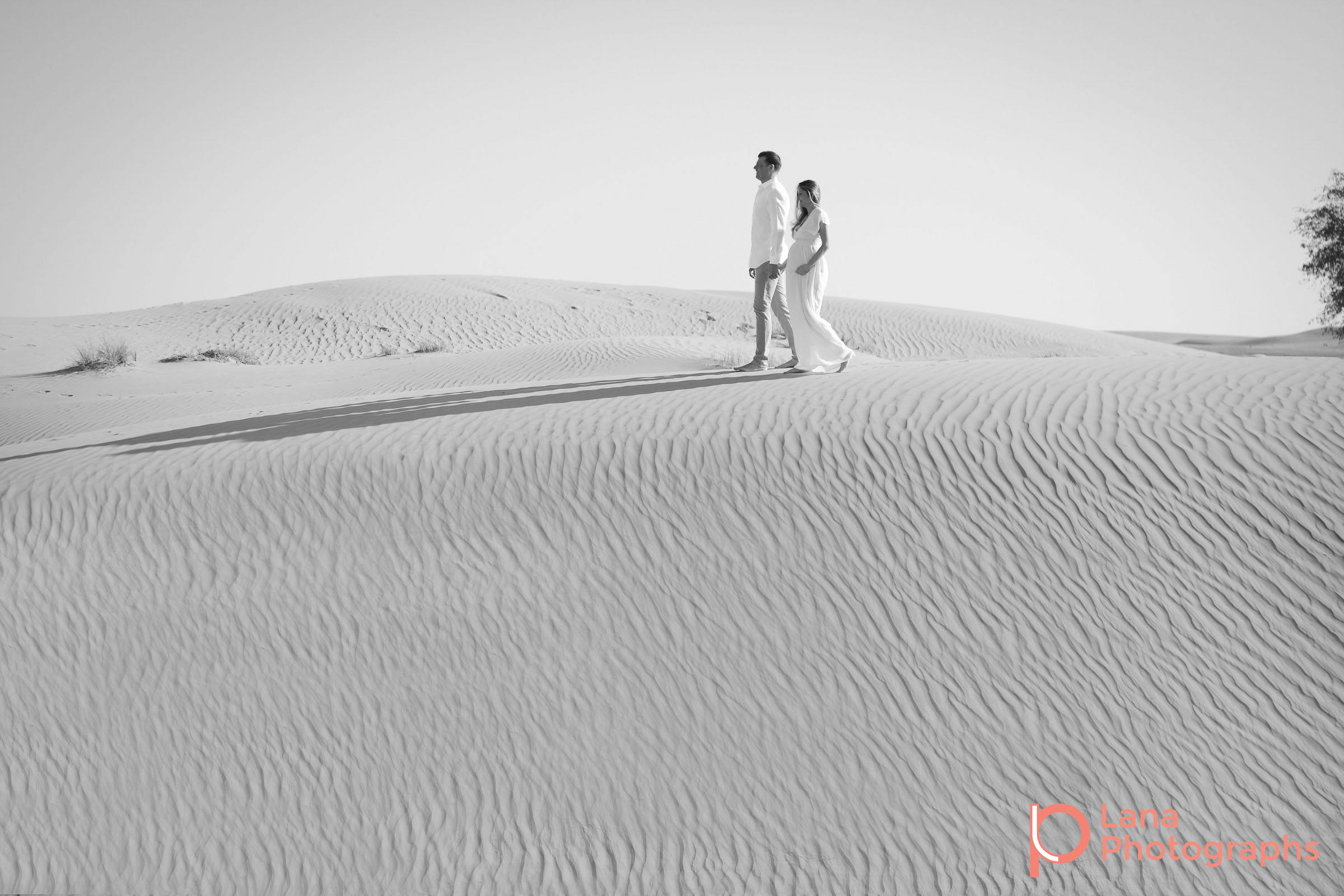 Dubai Maternity Photography portrait of expectant couple posing in the desert