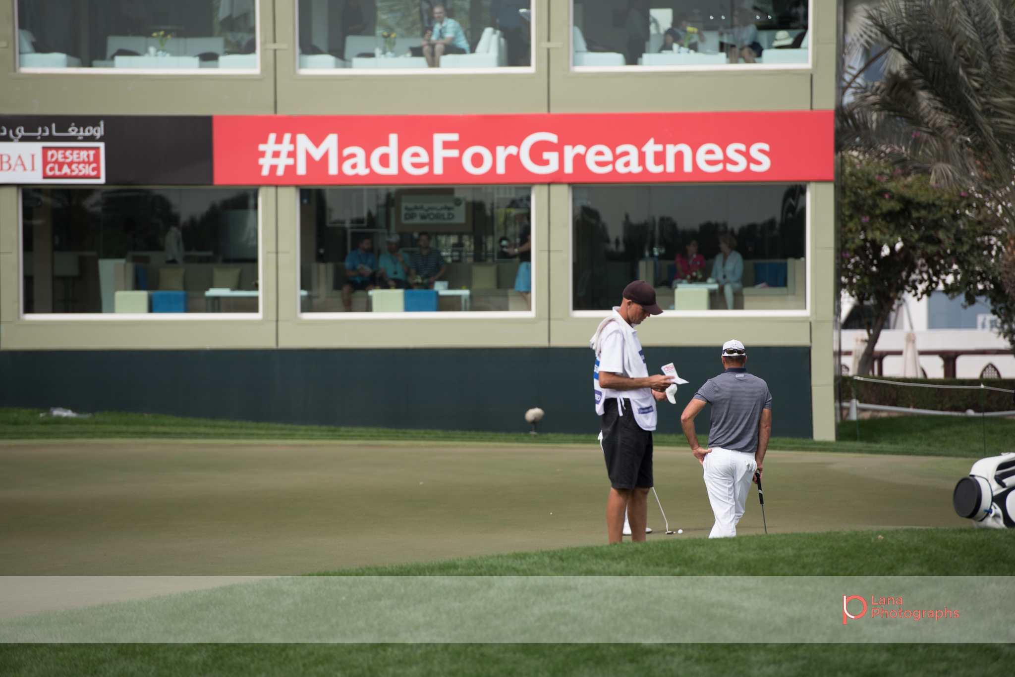 Grégory HAVRET stands in front of the #madeforgreatness sign at the Omega Dubai Desert Classic in February 2017