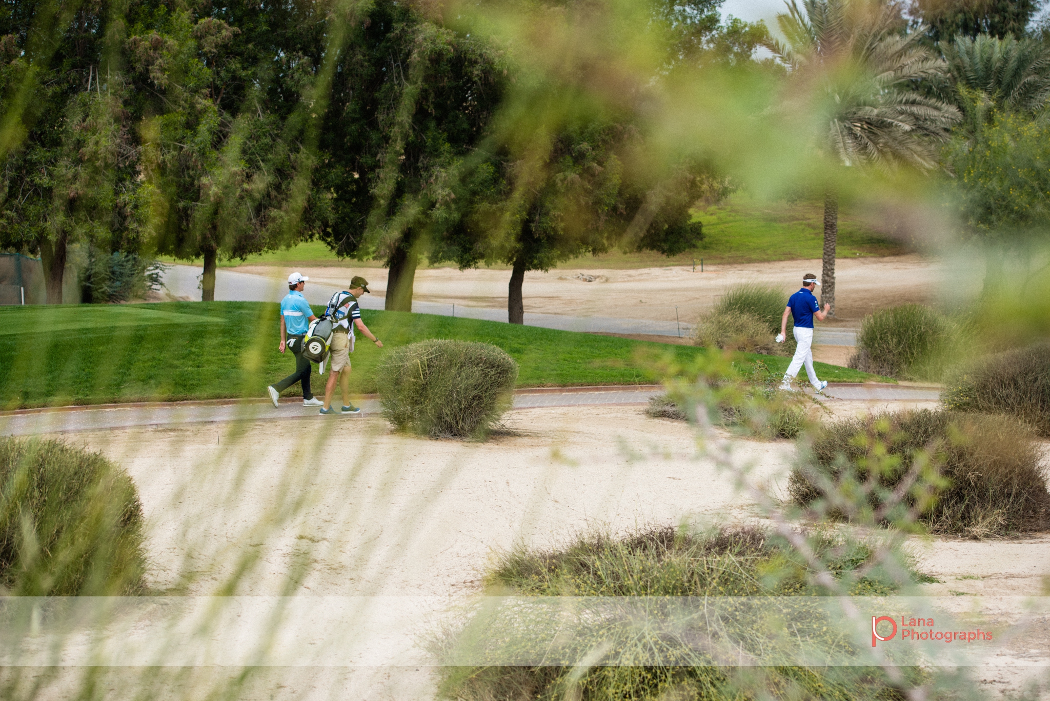Raphael Jacquelin leads the way as he walks across the grounds of the Emirates Golf Club in Dubai February 2017 during the Omega Dubai Desert Classic