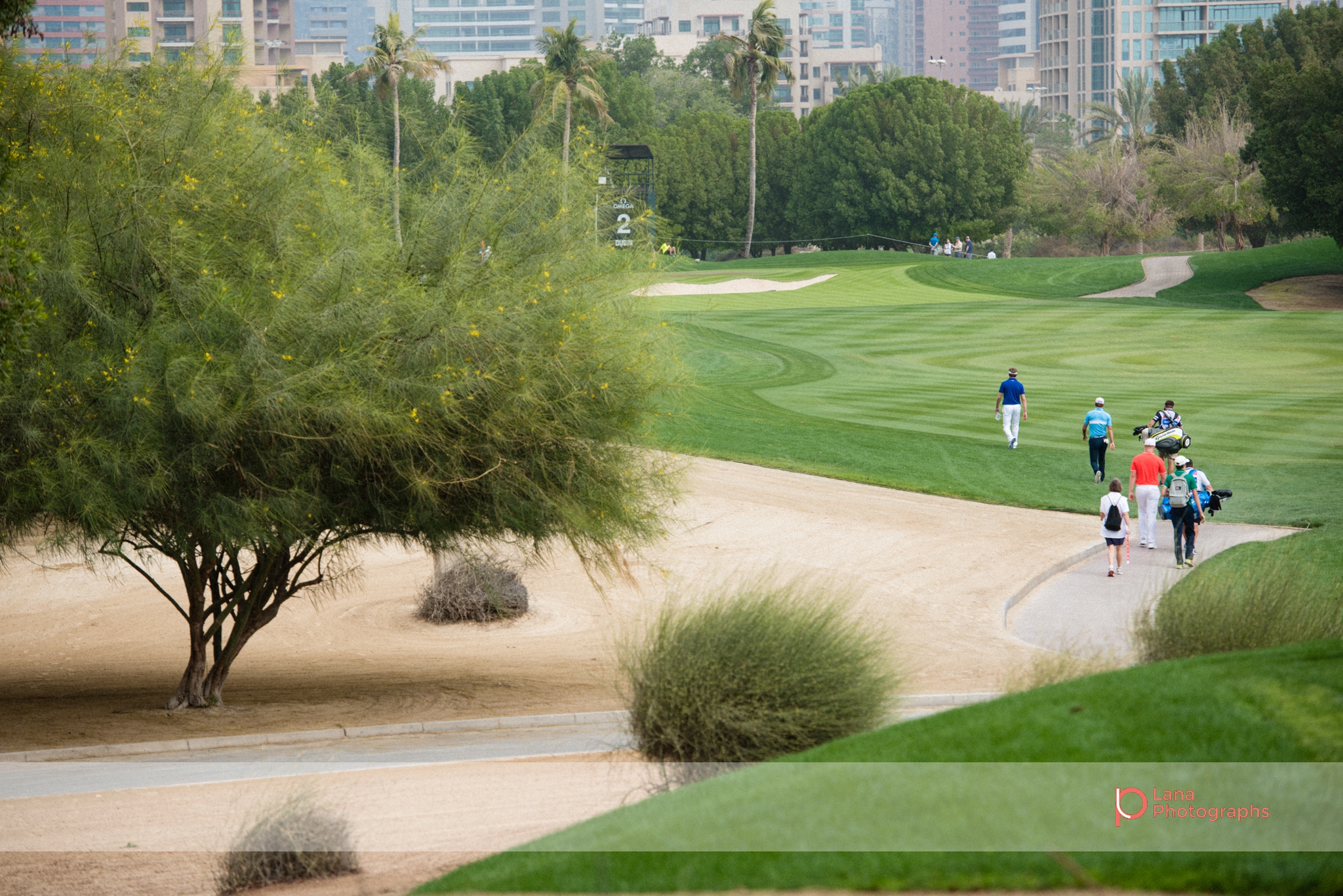   Raphael Jacquelin &nbsp;leads the way as he walks across the grounds of the Emirates Golf Club in Dubai February 2017 during the Omega Dubai Desert Classic with a view of Dubai Marina in the background 