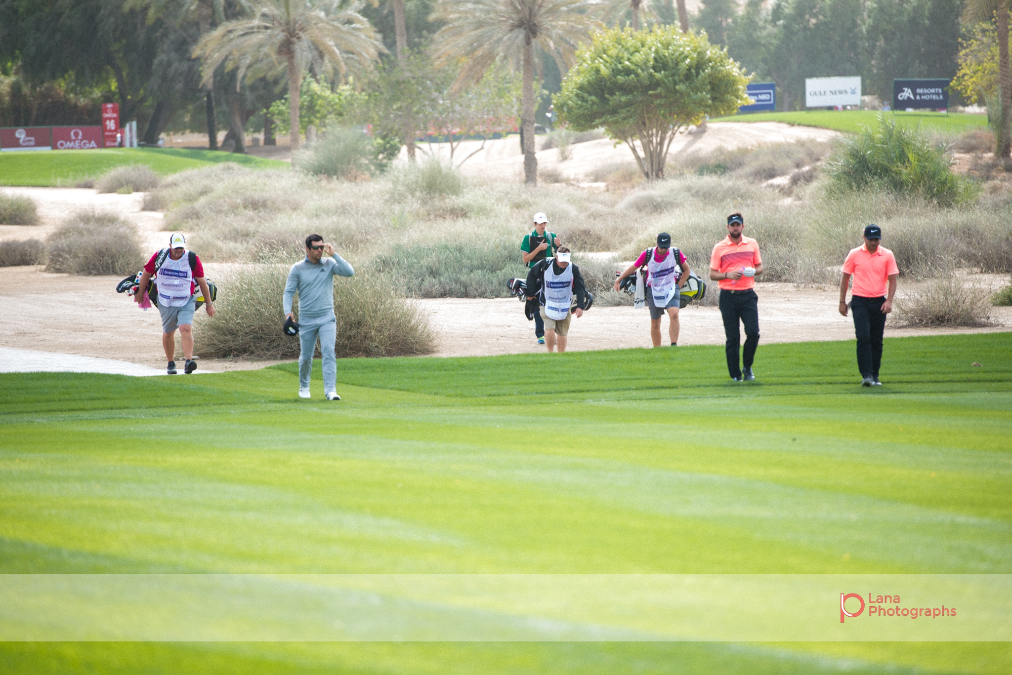  Caddie players join their golfing pros as they walk across the grounds of the Emirates Golf Course in February 2017 