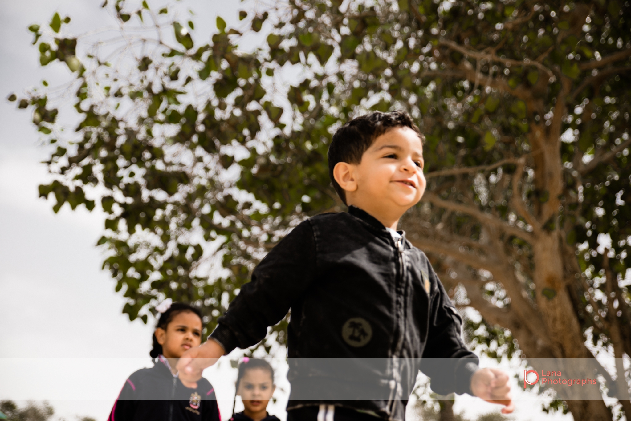 Dubai Family Photographer little boy running in Umm suqeim park Dubai