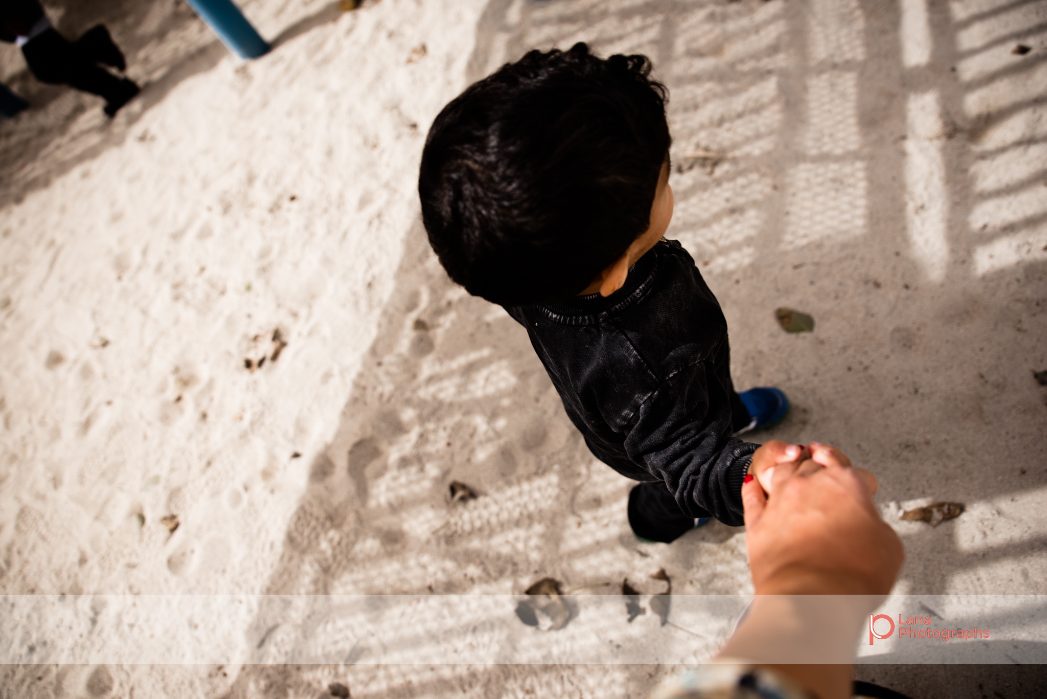 Dubai Family Photographer little boy holding his mother's hand in Umm suqeim park Dubai